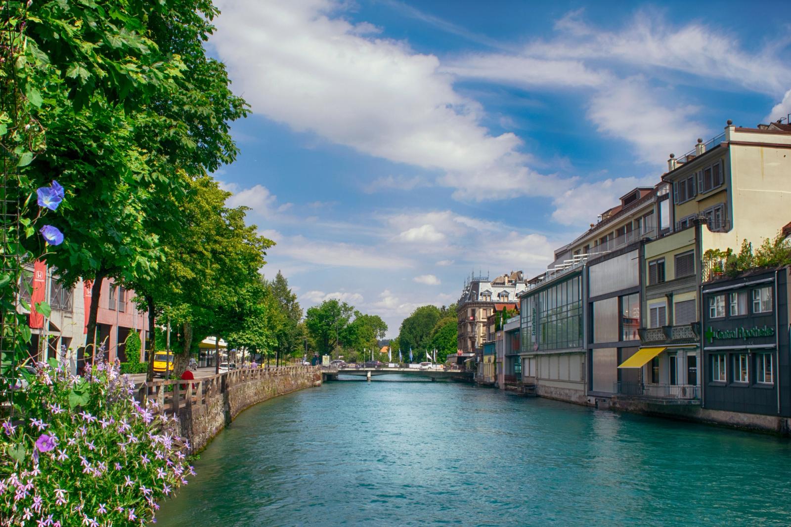 A sunny day view of a picturesque canal and colorful buildings
