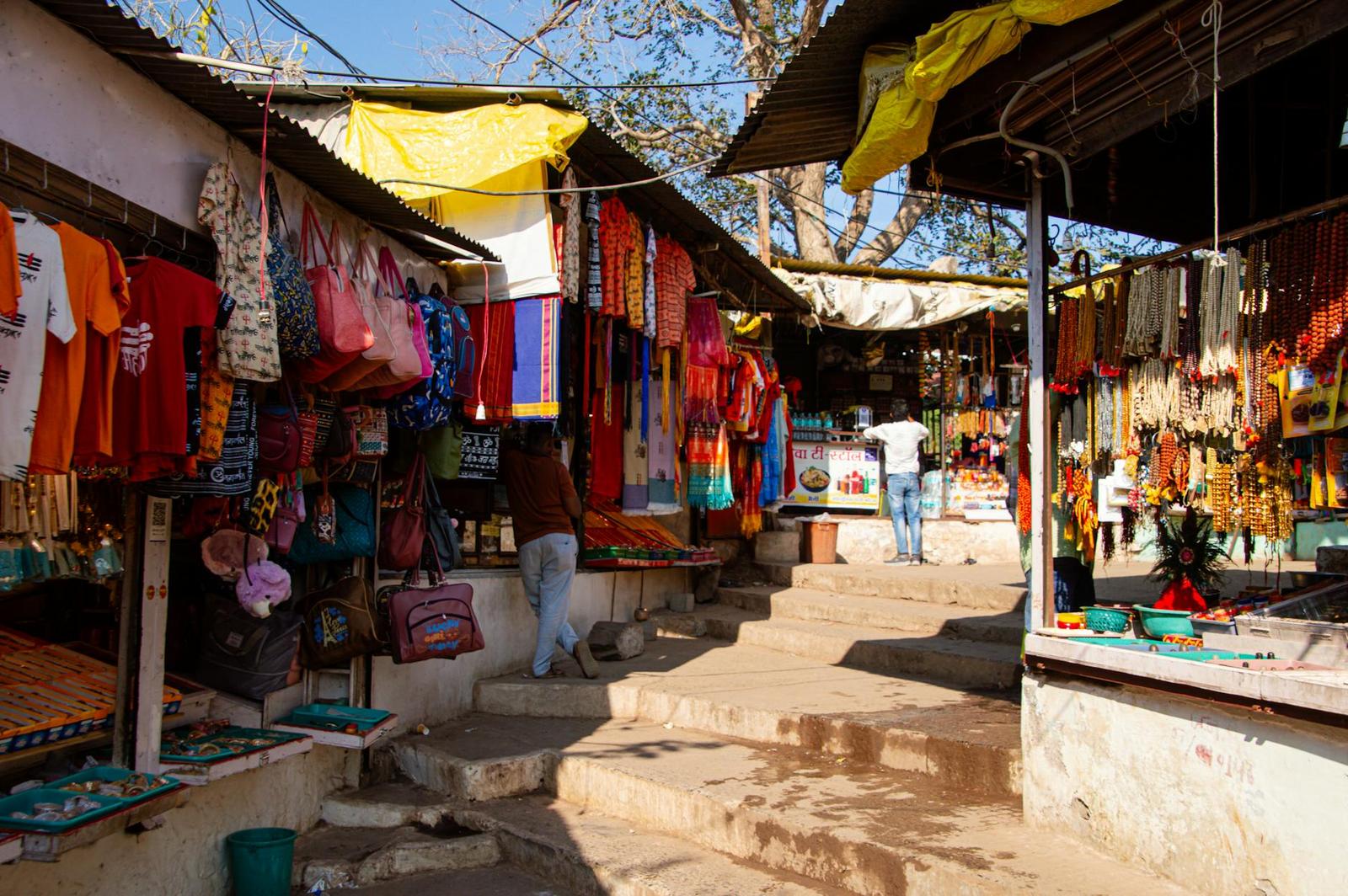 Colorful textiles and bags hanging at a hillside roadside market