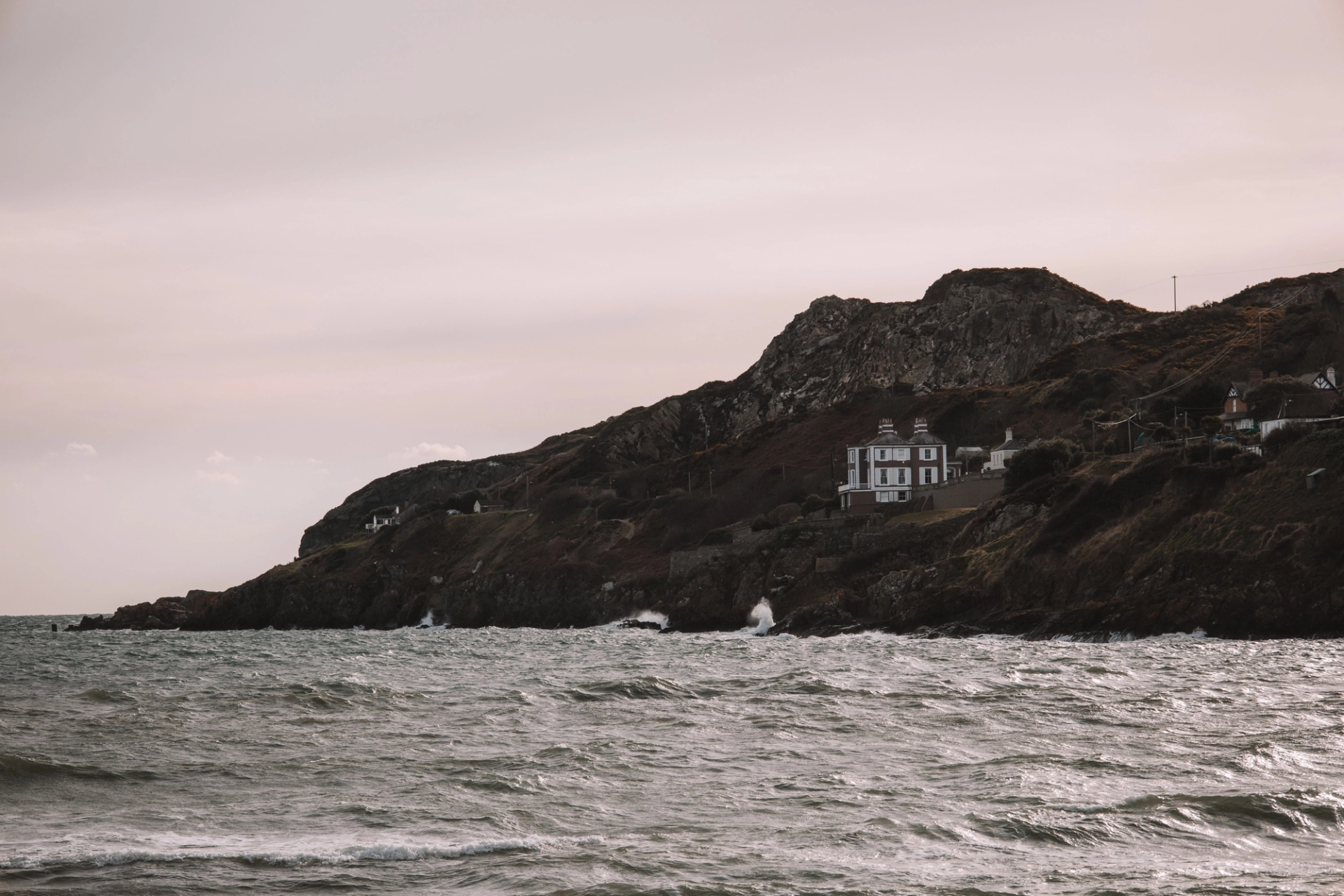 A picturesque view of Howth Head's rugged coast in Dublin, Ireland, with a serene ocean backdrop