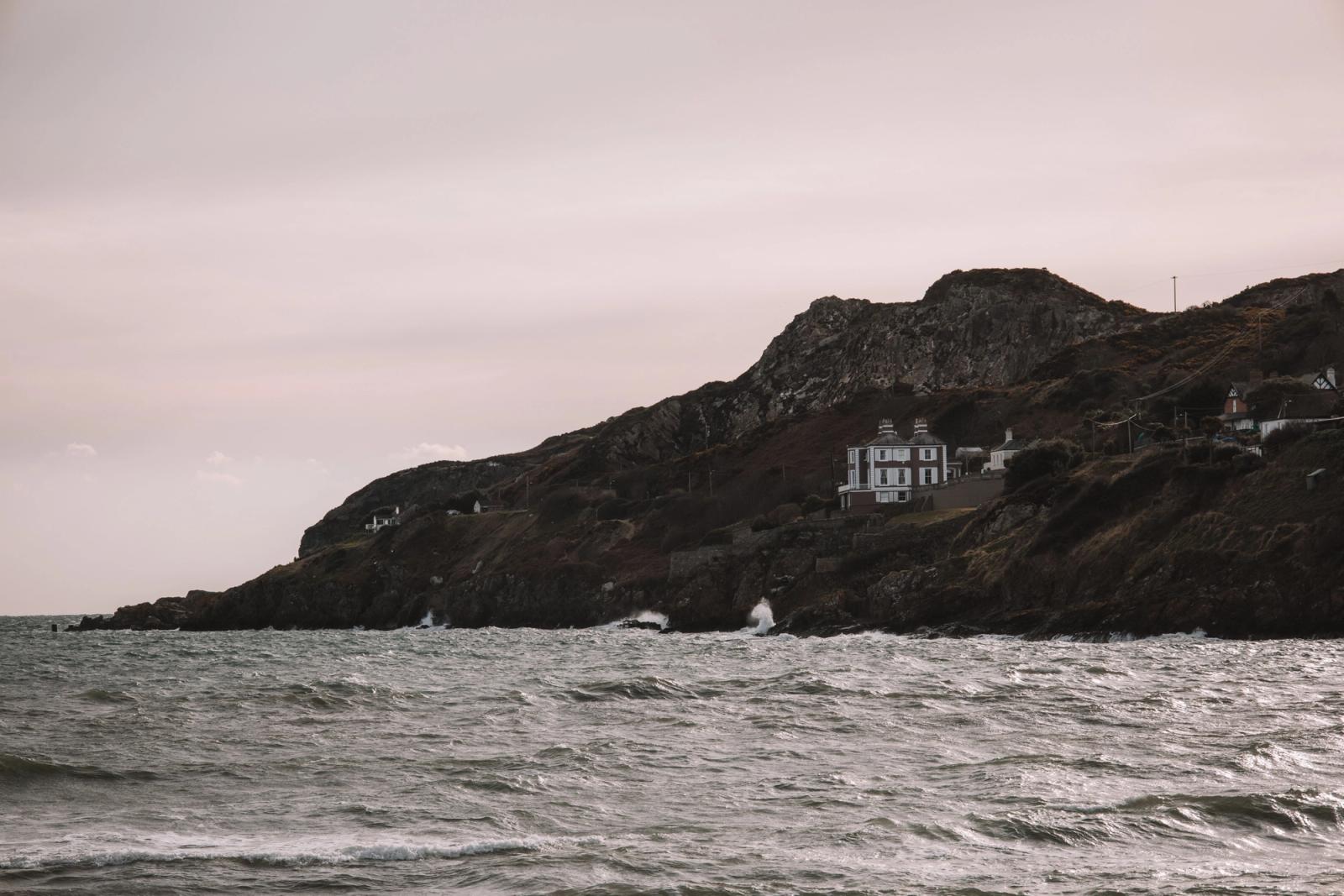 A picturesque view of Howth Head's rugged coast in Dublin, Ireland, with a serene ocean backdrop