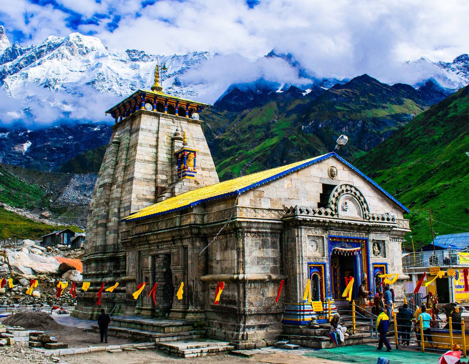 Kedarnath Temple's stone spire standing before snow covered Himalayan peaks