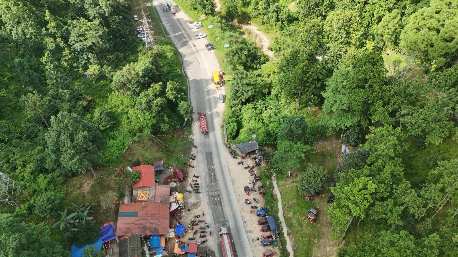 Aerial photo showing a vibrant highway scene surrounded by lush greenery in Nepal