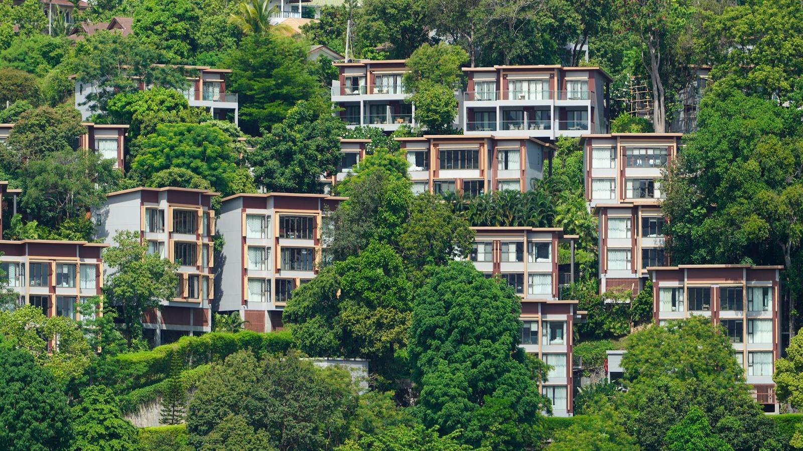 Aerial view of hillside villas nestled among dense tropical trees