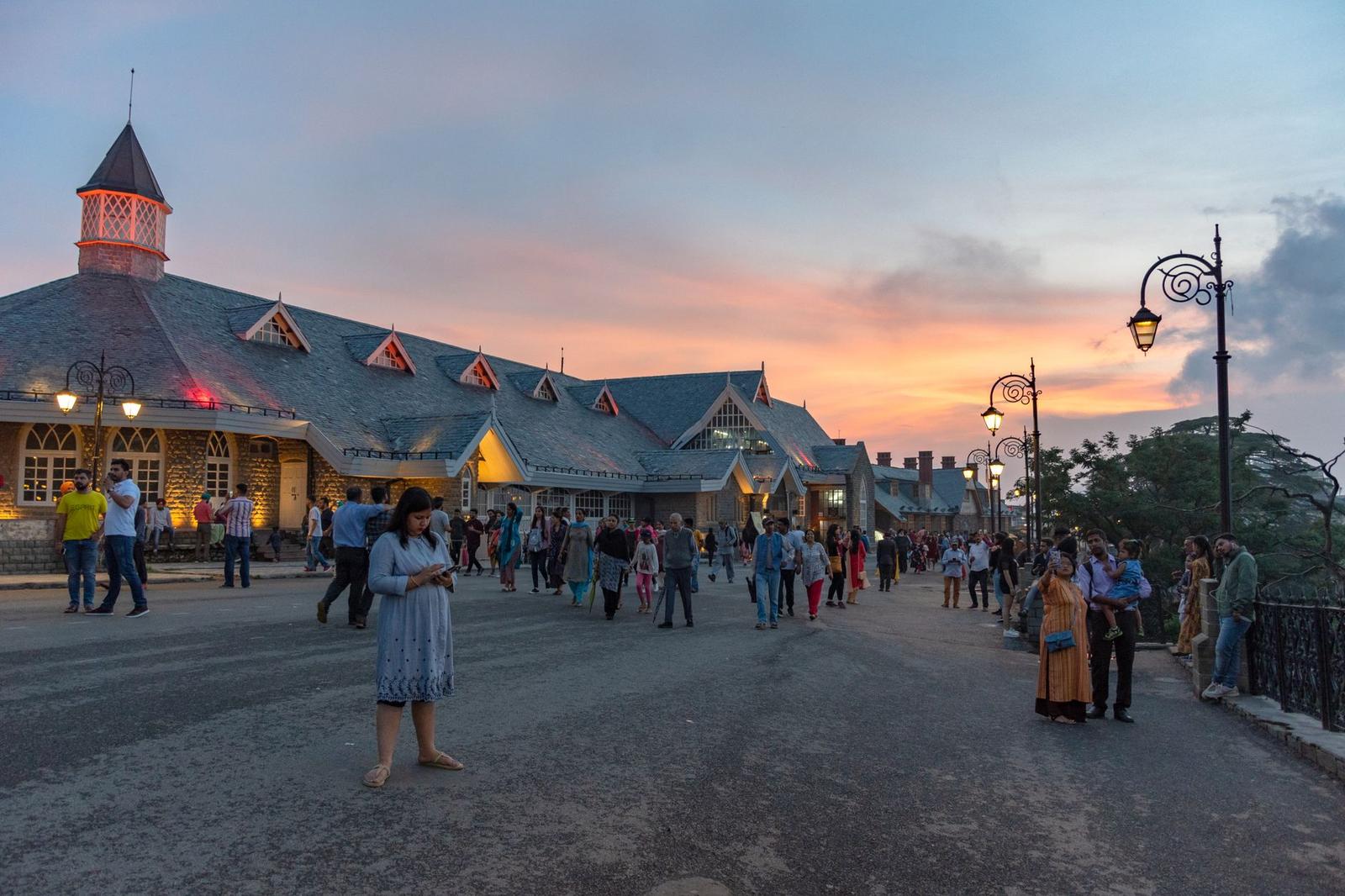 Evening scene with people near Indian landmark during sunset