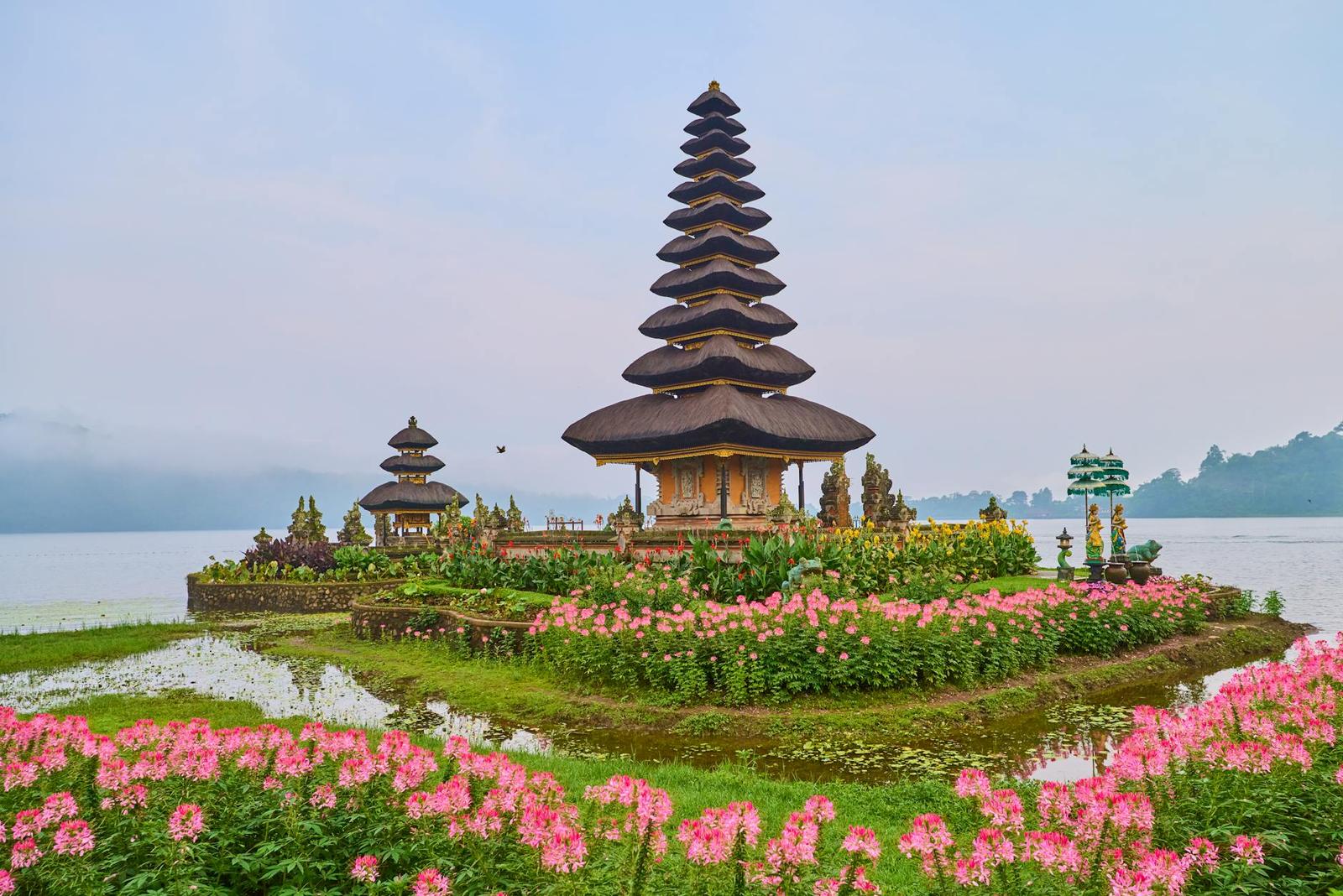 Beautiful Ulun Danu Beratan Temple in Bali, surrounded by colorful flowers and a serene lake
