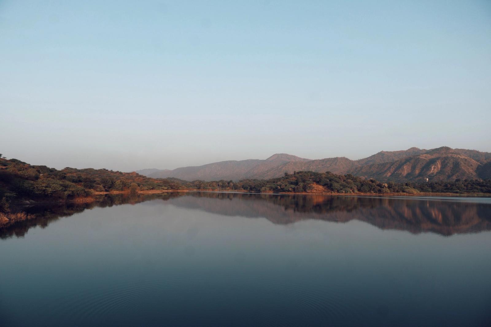 Serene lake with mountain reflections in Mount Abu, Rajasthan, India