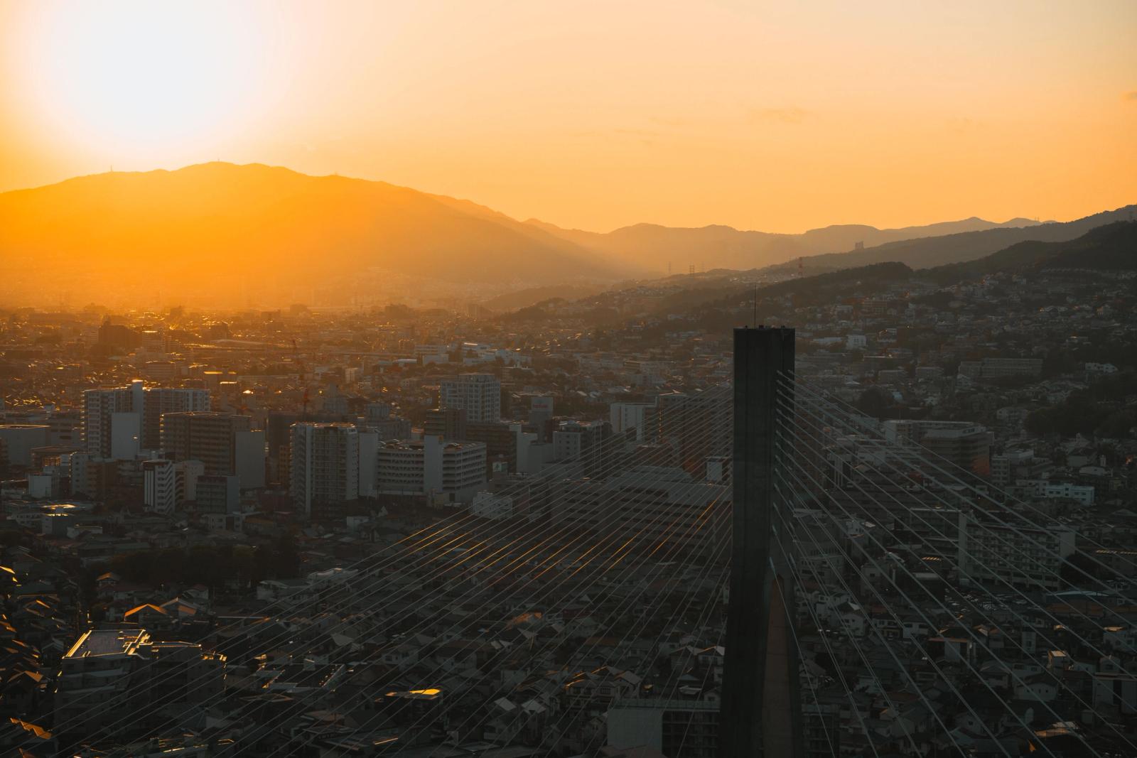A beautiful sunset over the skyline of Ikeda, Osaka, Japan, highlighting cityscape and mountains