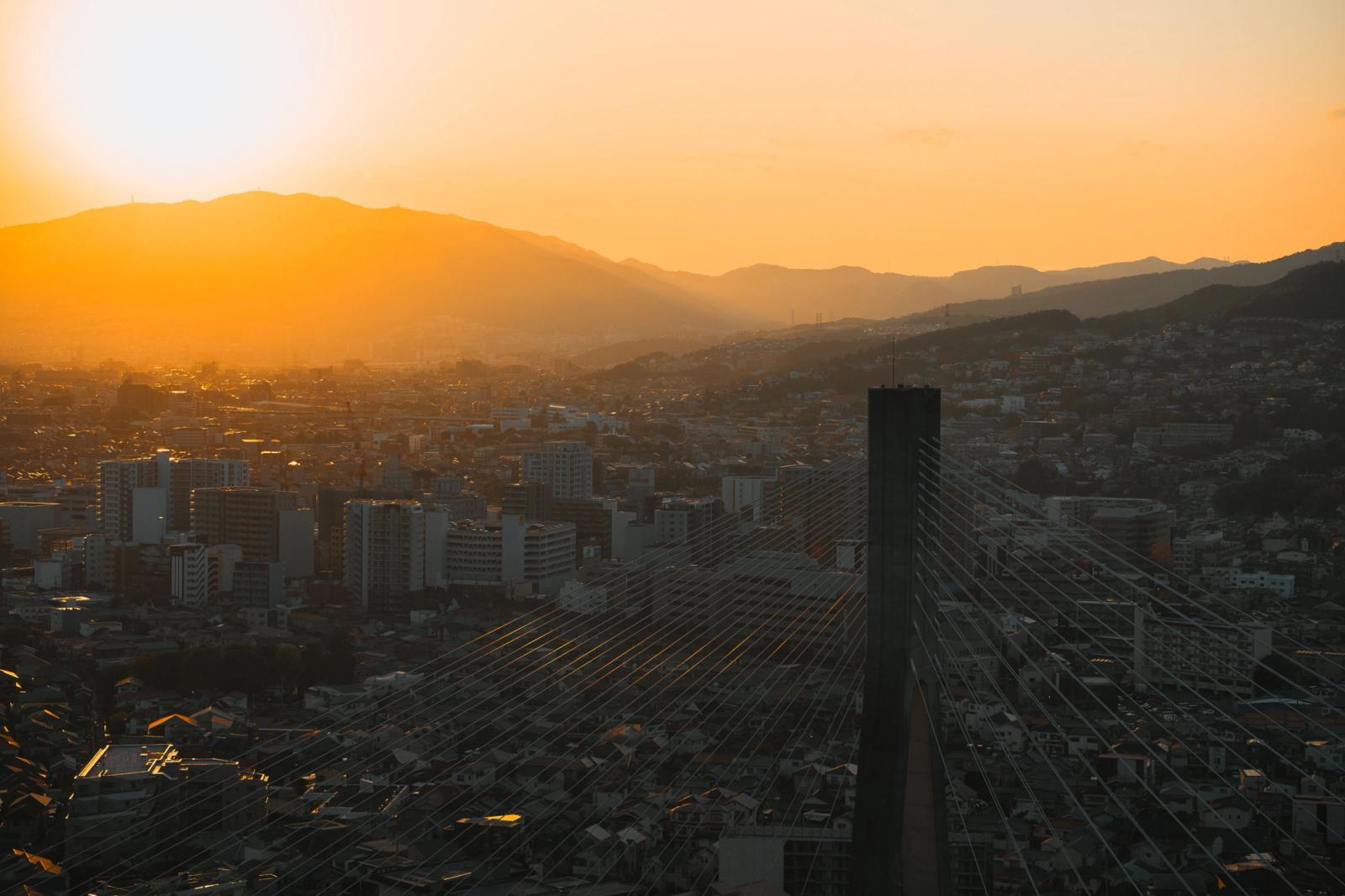 A beautiful sunset over the skyline of Ikeda, Osaka, Japan, highlighting cityscape and mountains