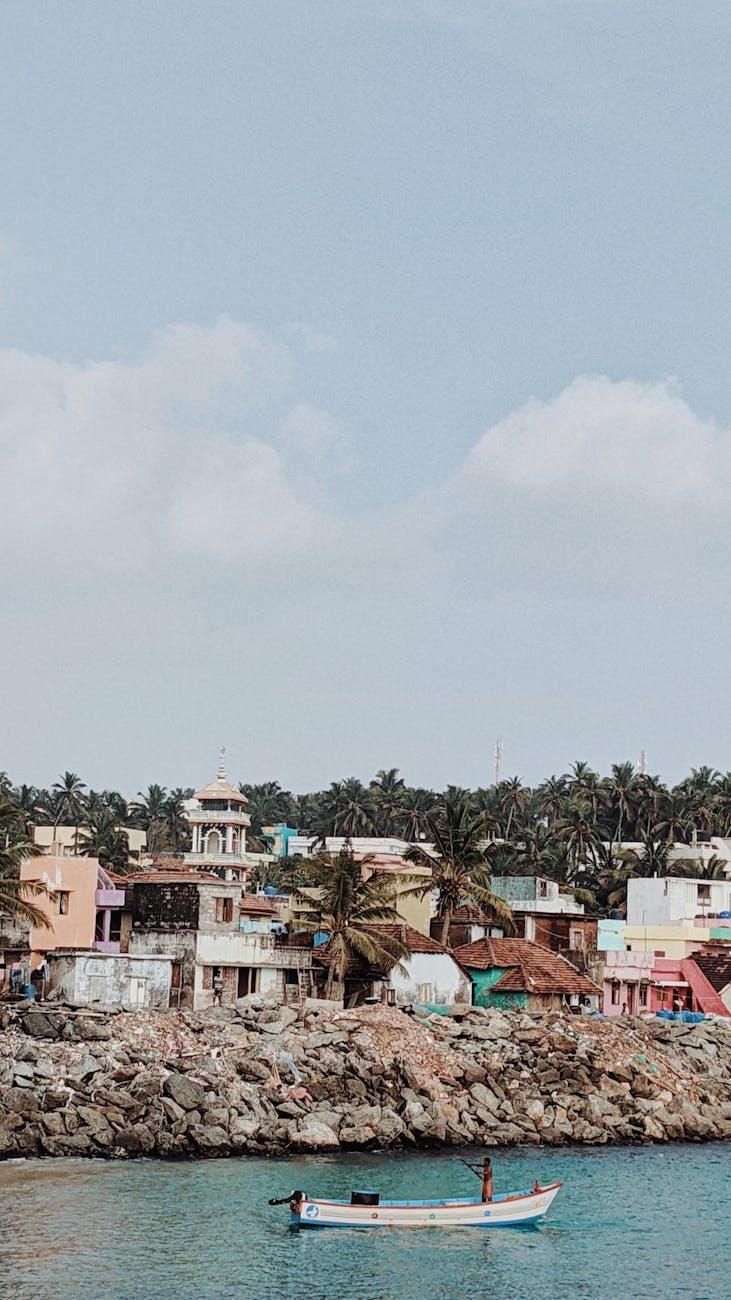 Charming coastal village with vibrant homes and a small boat in tranquil waters