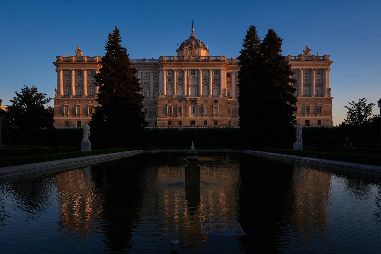 Majestic view of the Royal Palace of Madrid reflecting in the Sabatini Gardens pool during twilight