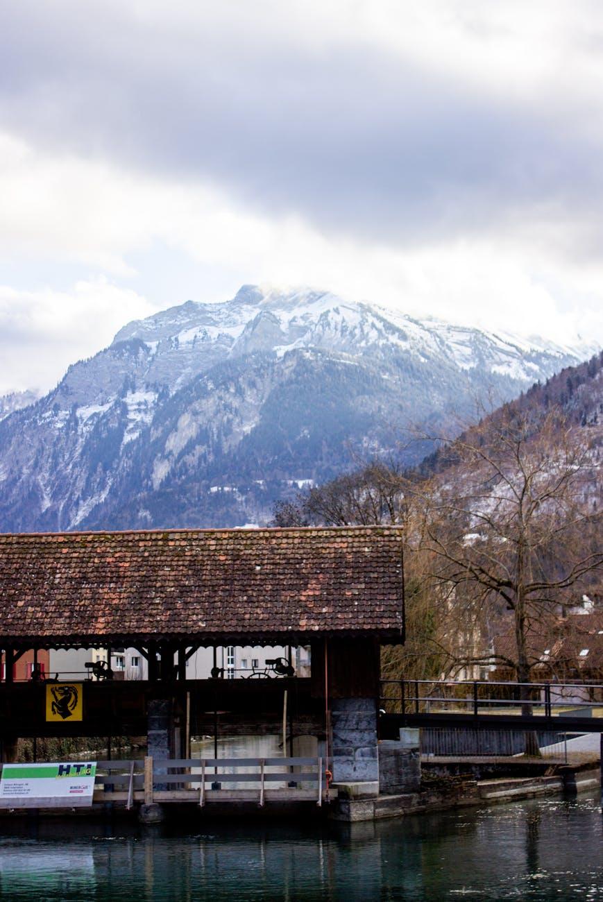 Beautiful landscape view of Interlaken, Switzerland, featuring snowy mountains and a rustic wooden structure