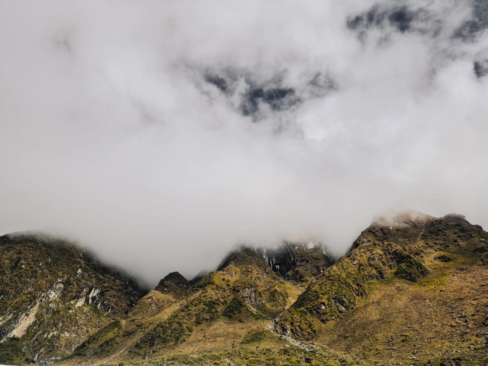 Dramatic mist-covered mountains with cloudy skies in Kedarnath, India