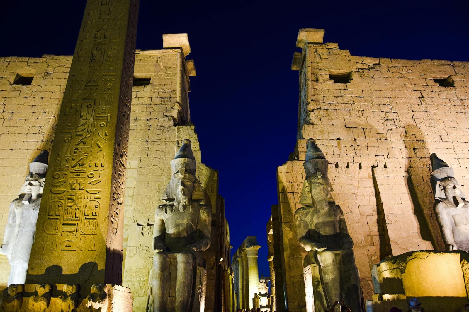 Night view of the illuminated Luxor Temple with ancient statues and hieroglyphs