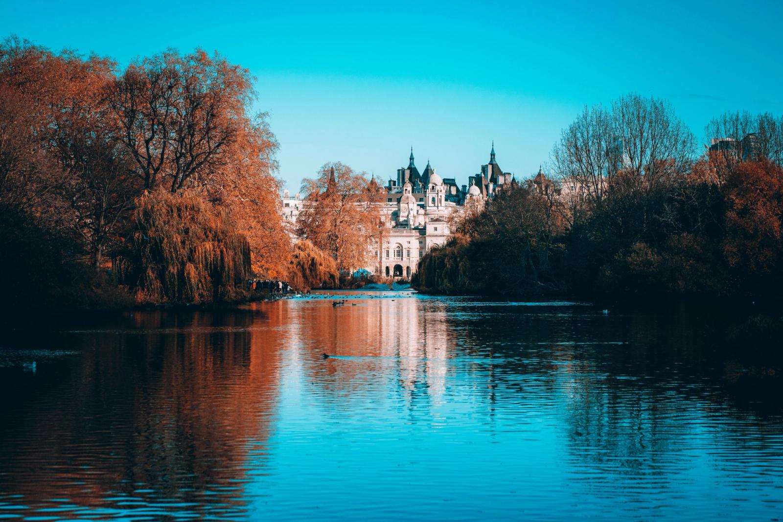 Serene autumn scene at St James Park, London with palace reflection in the lake