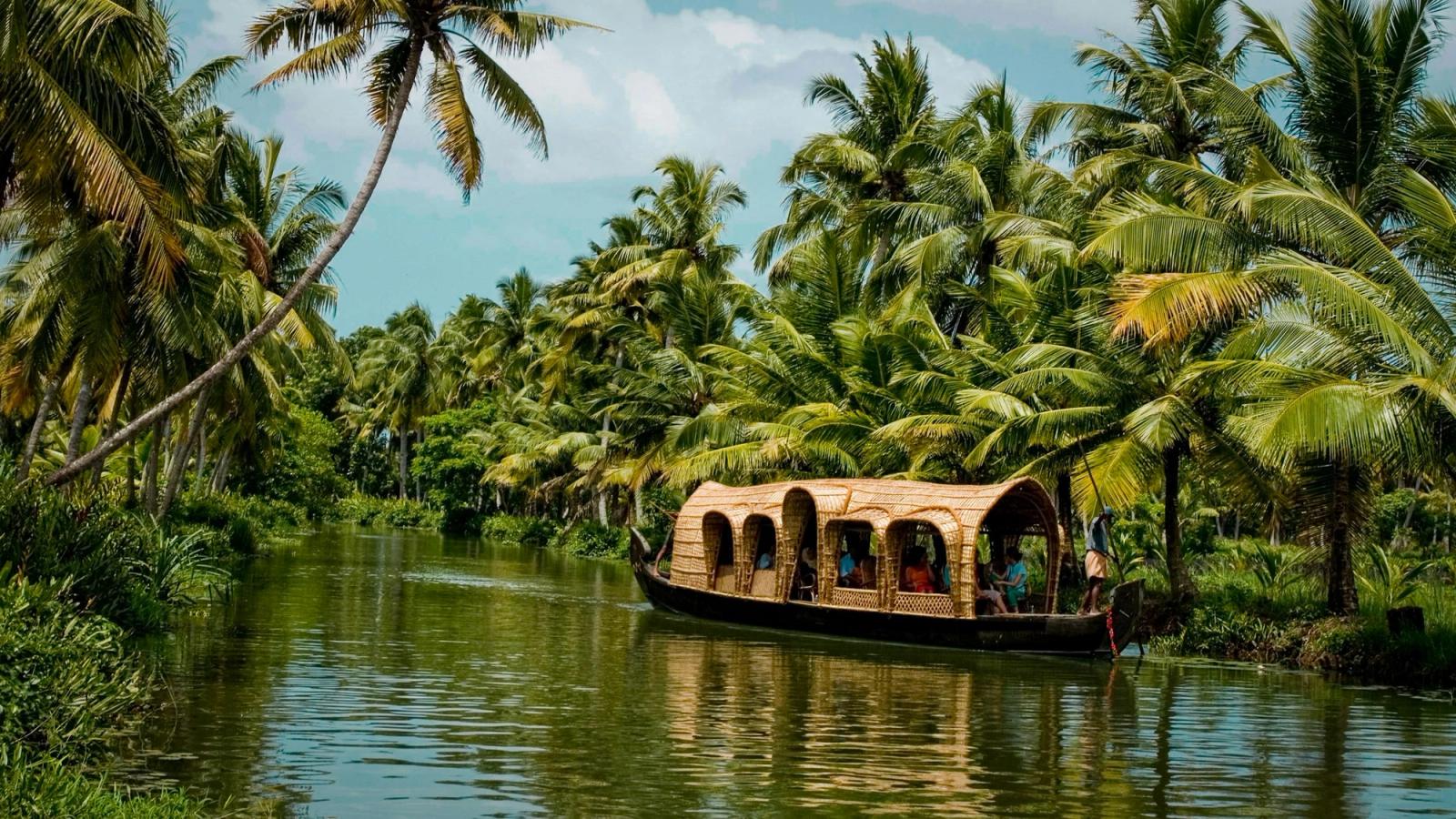 A houseboat drifting through Kerala's palm-lined backwaters.