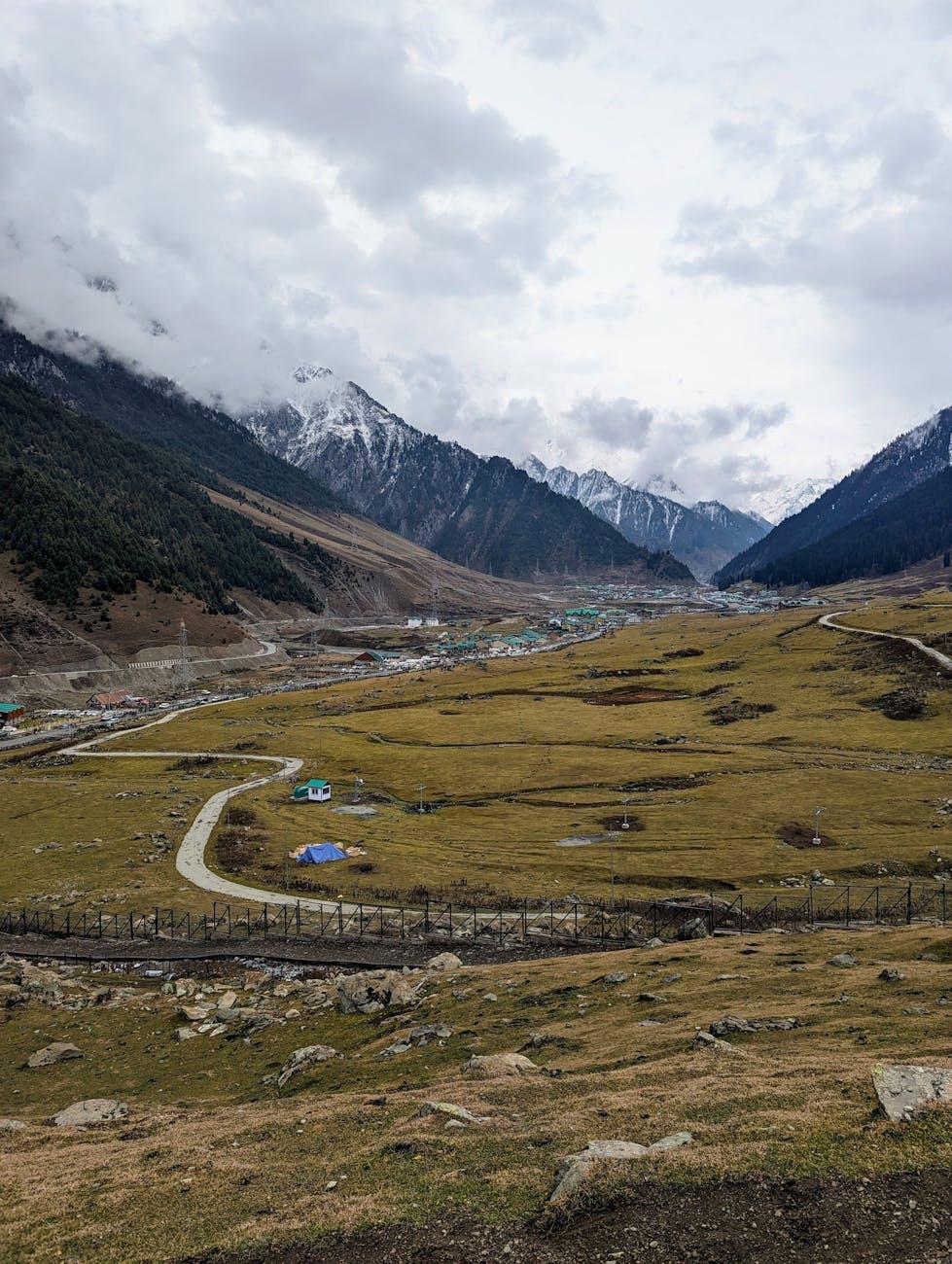 A breathtaking view of Sonamarg valley with lush landscapes and snow-capped mountains in spring