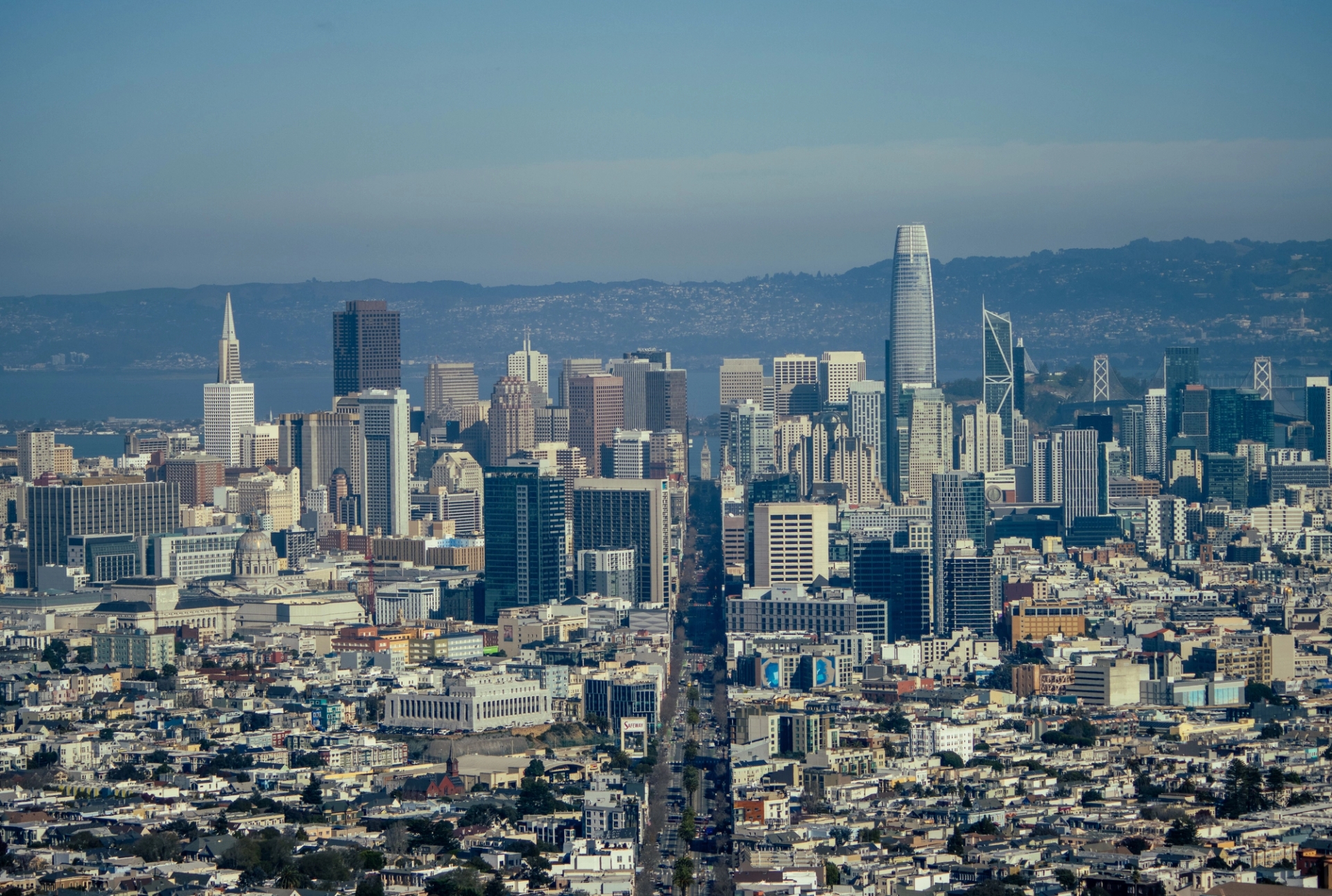 Aerial view of San Francisco's skyline featuring iconic skyscrapers under a clear blue sky