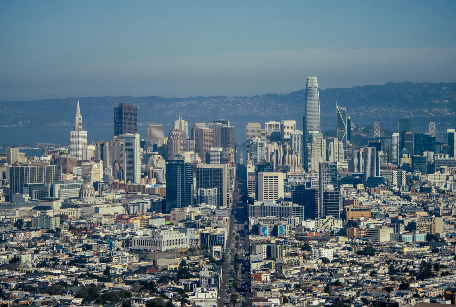 Aerial view of San Francisco's skyline featuring iconic skyscrapers under a clear blue sky