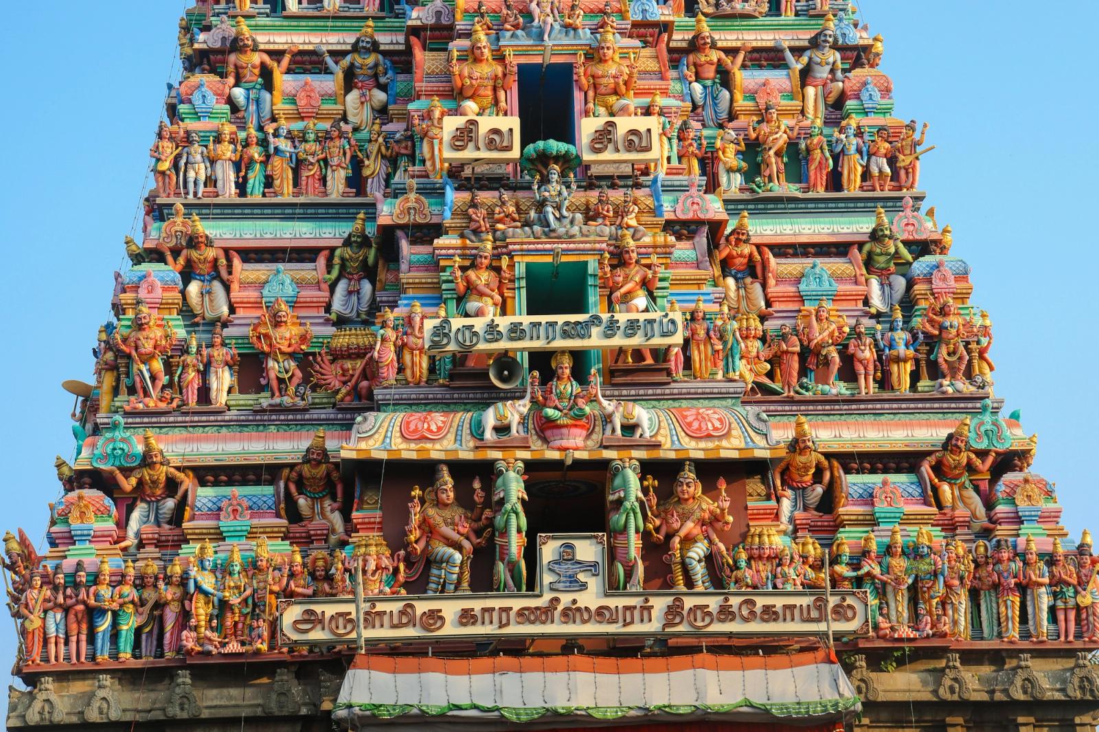 Intricately ornamented facade of a Hindu temple in Chennai, showcasing colorful statues and religious motifs