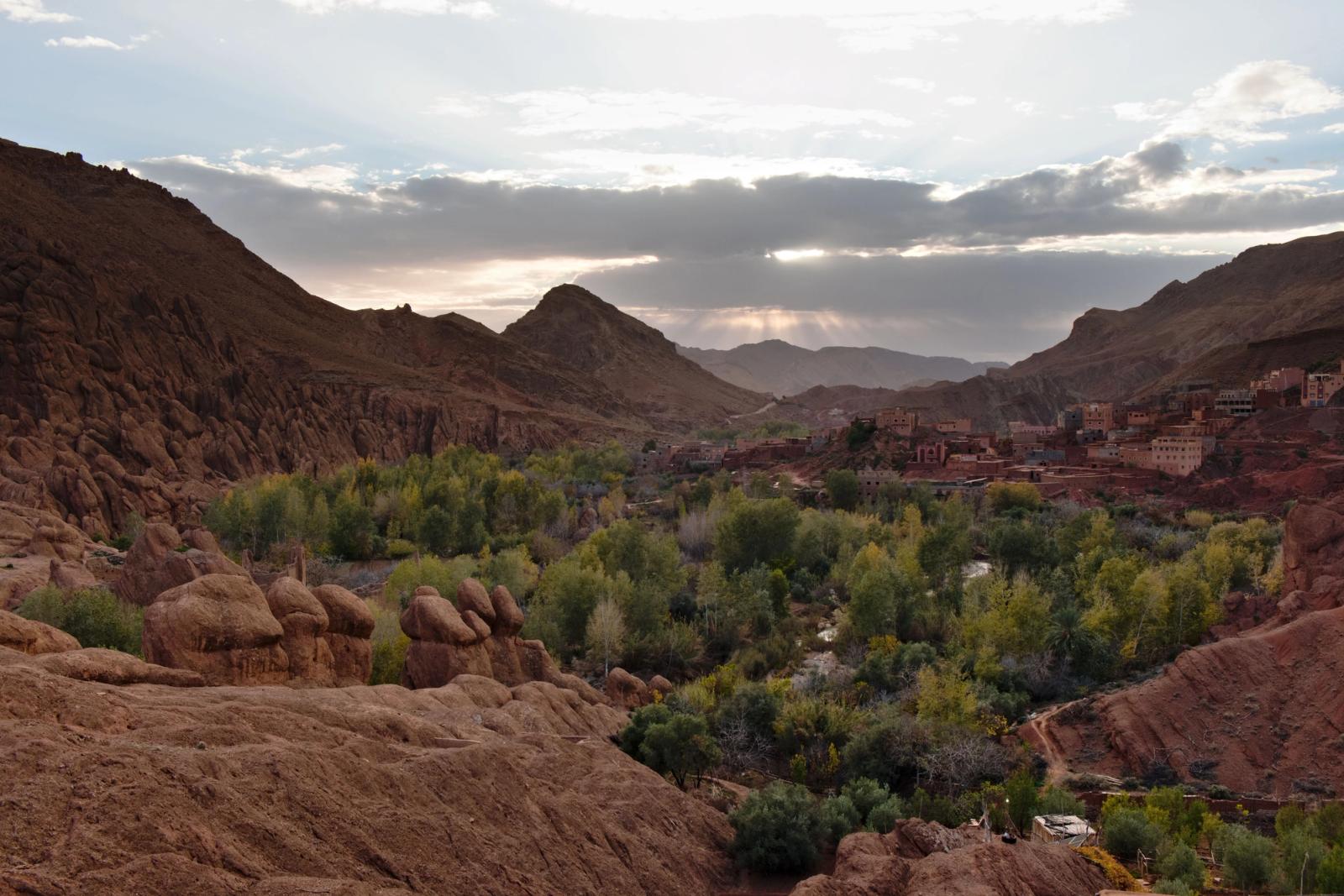 Beautiful valley in Morocco with lush greenery and rocky mountains under a twilight sky