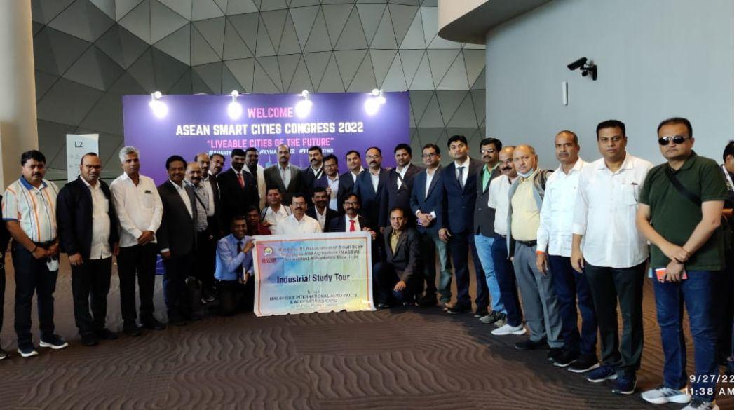 A group of smiling people holding a large check