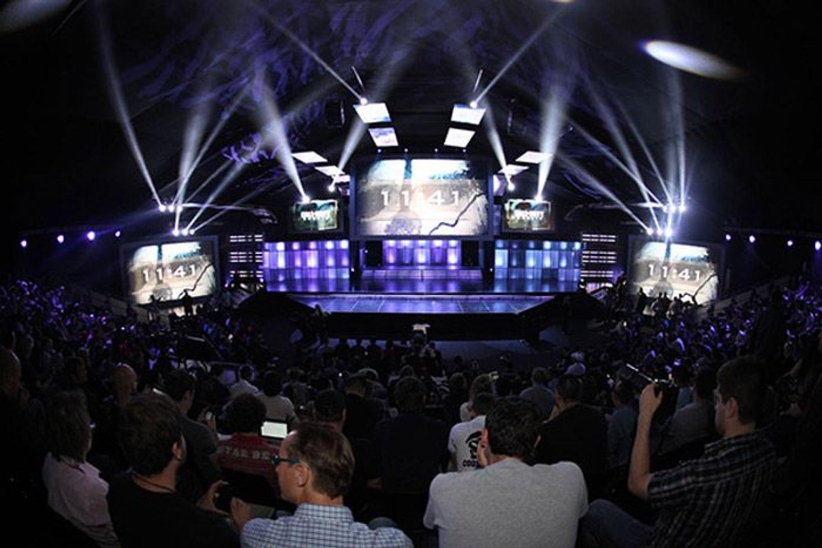 Stage lights over a crowd at an evening event