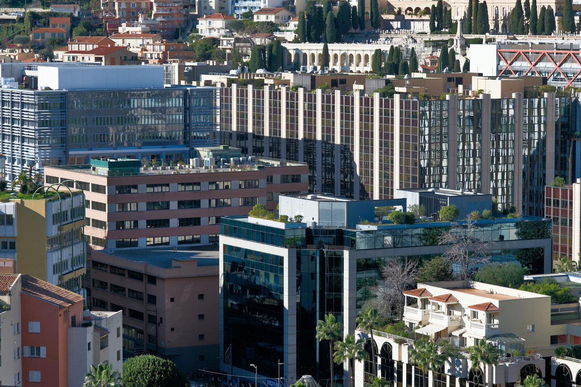 Dense cluster of glass office and apartment towers on a hillside