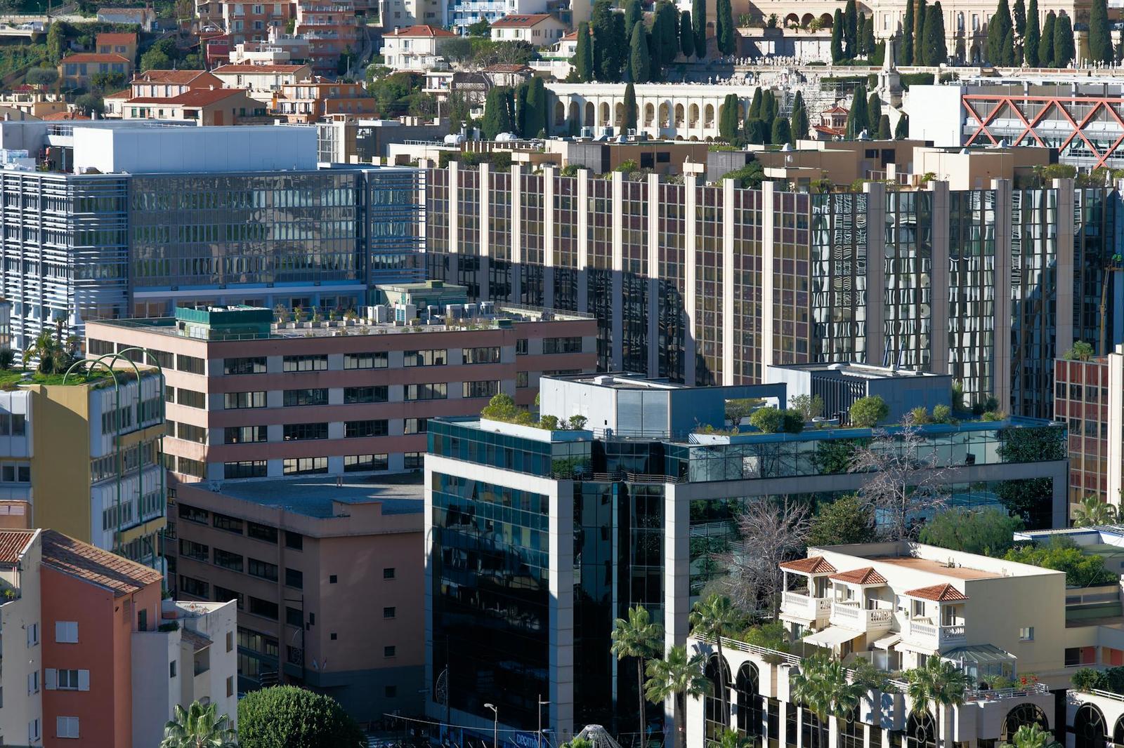 Dense cluster of glass office and apartment towers on a hillside