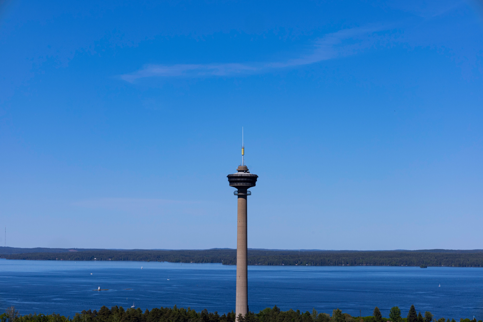 A scenic view of the Näsinneula Observation Tower in Tampere, Finland, under a clear blue sky