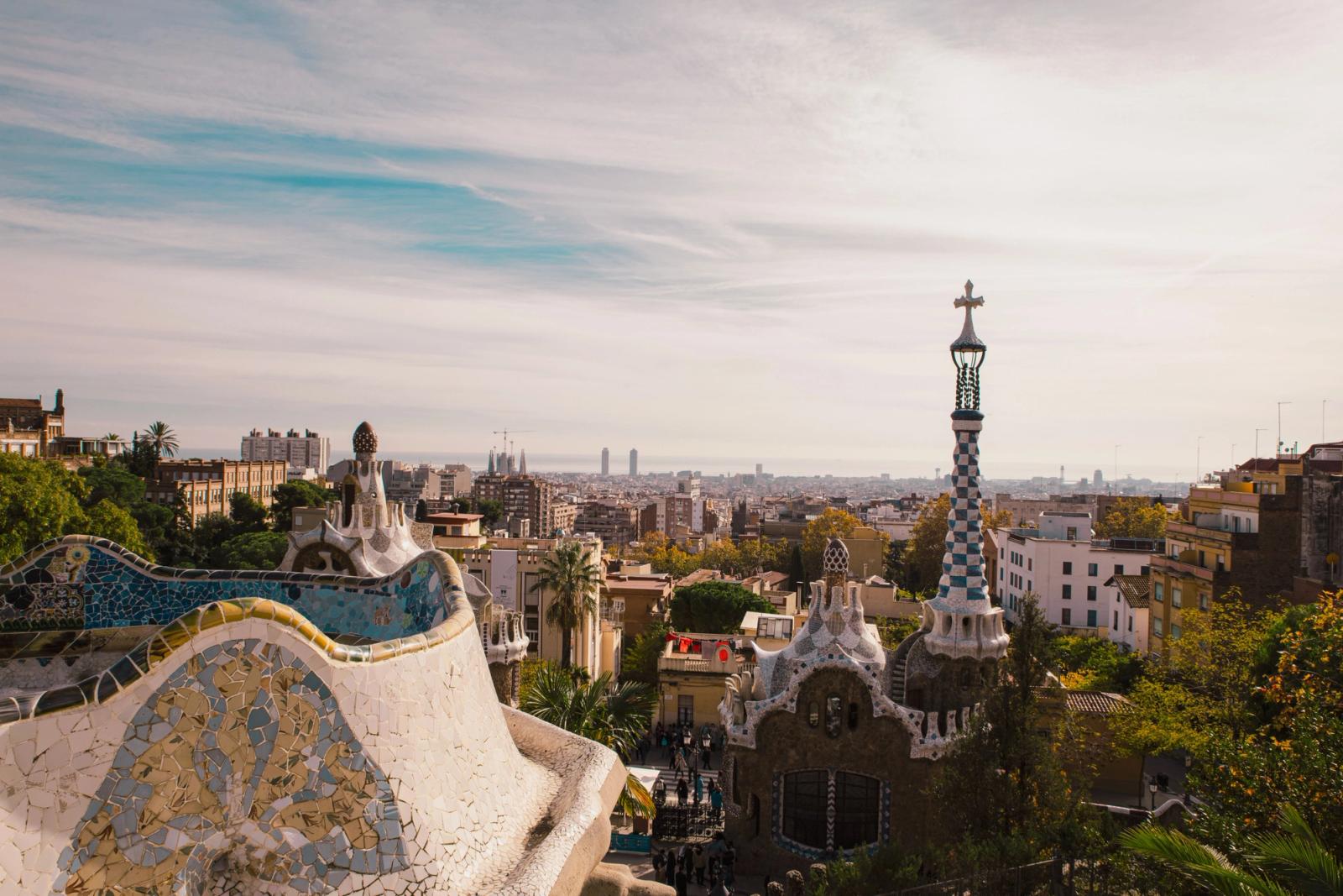 Captivating view of Barcelona city skyline from iconic Park Güell, featuring Gaudi architecture