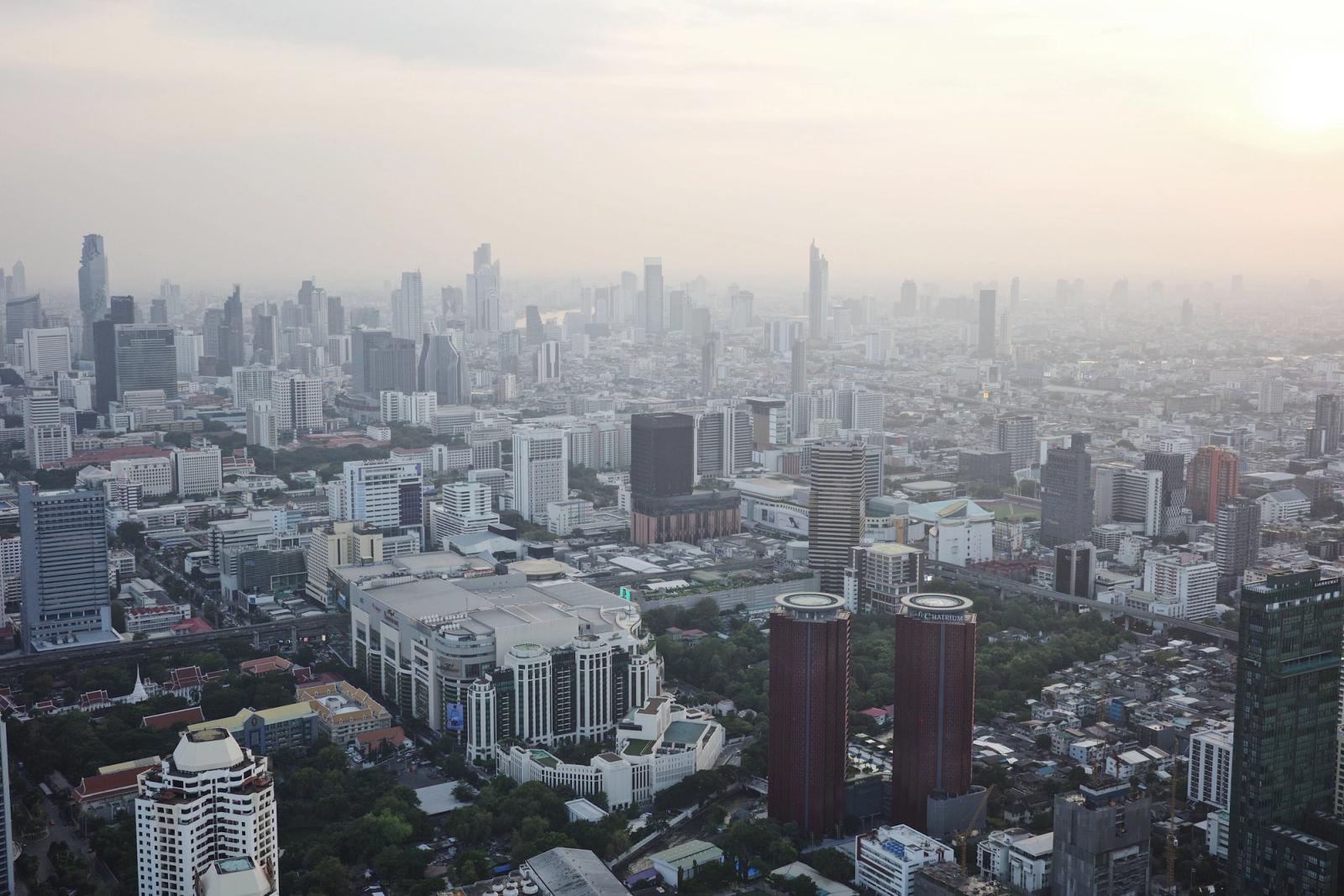 Dramatic aerial view of Bangkok skyline, highlighting the modern urban landscape at sunset
