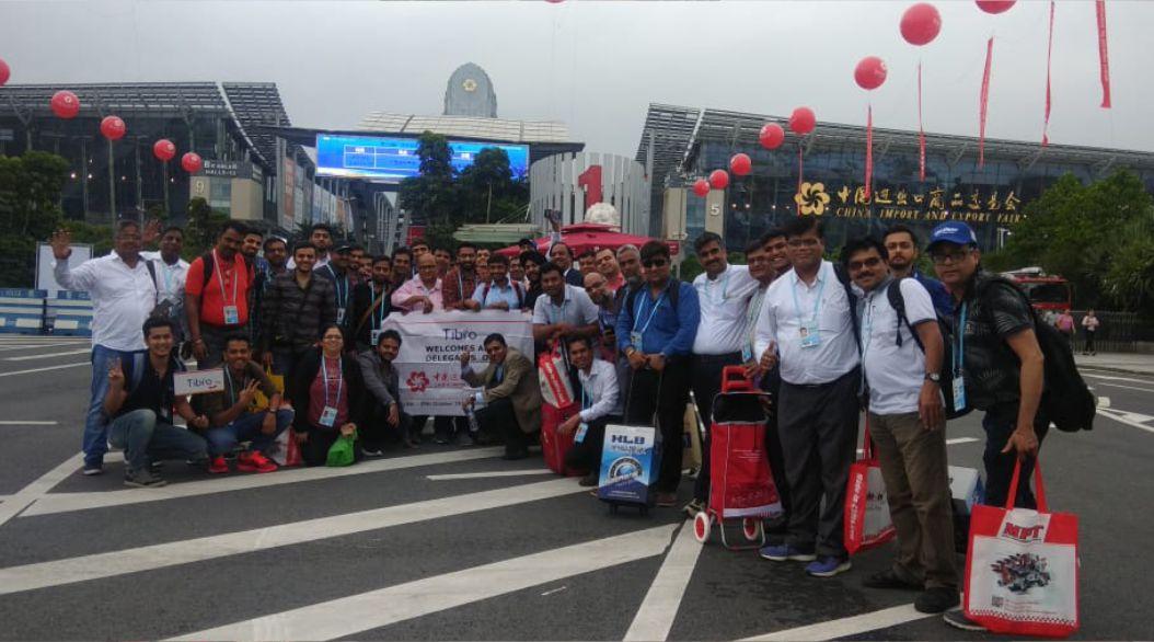 Group of people smiling and posing on a road