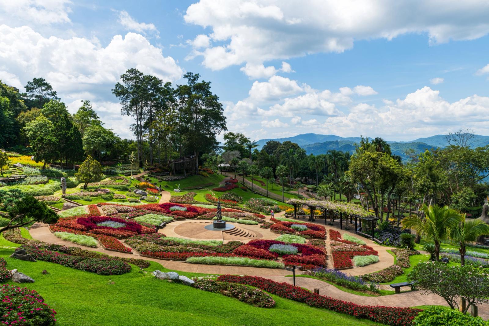 Manicured garden beds in circular patterns overlooking wooded hills