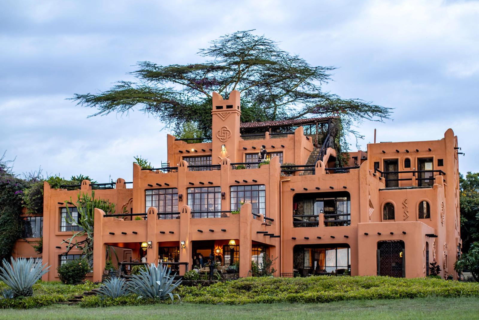 Beautiful adobe-style architecture surrounded by vibrant greenery, captured at dusk