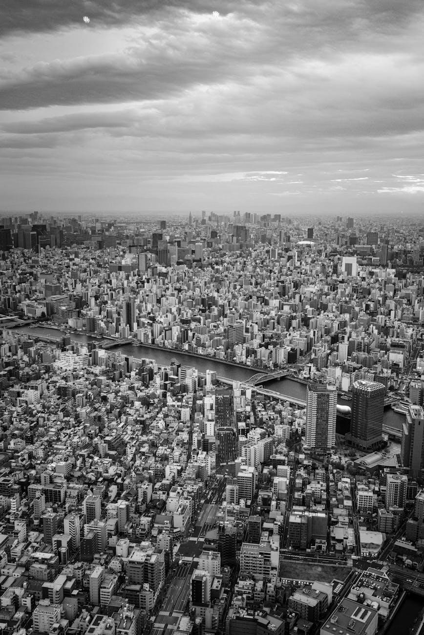 Black and white aerial view of a dense city skyline following a river