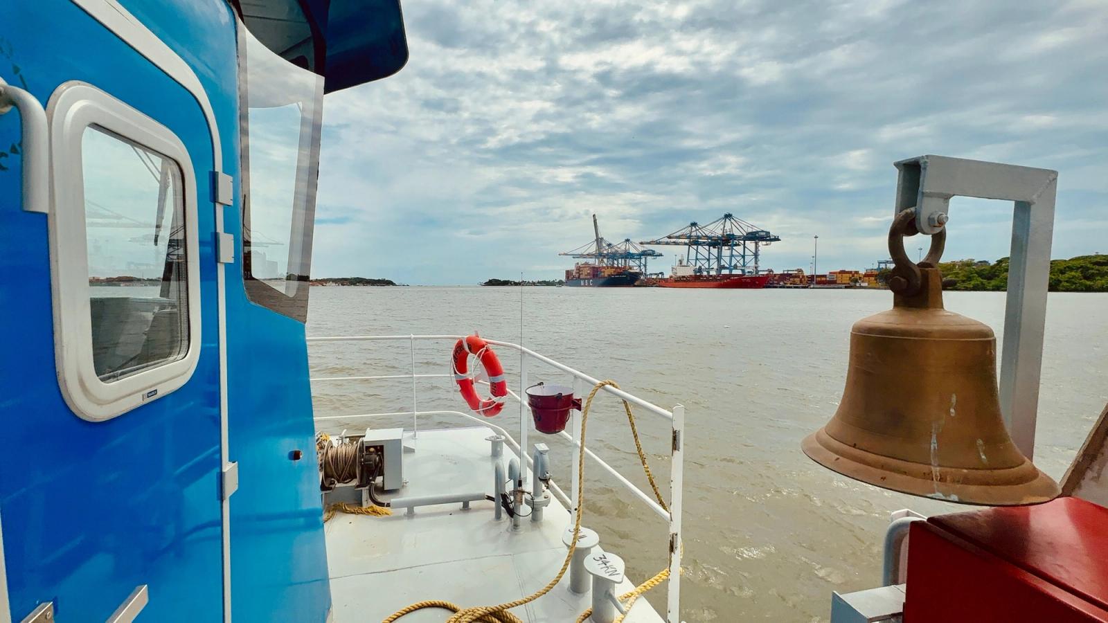 View from a ship deck at Cochin Port overlooking cranes and containers under a cloudy sky