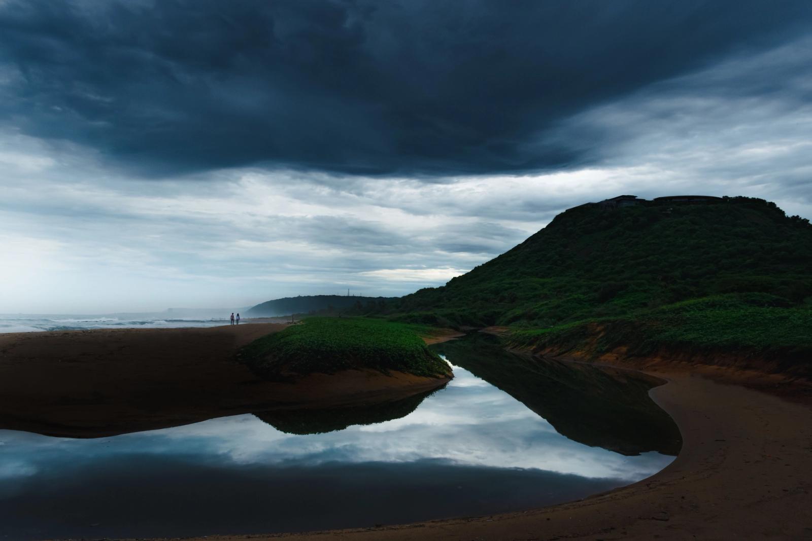 A scenic view of a stormy sky over a serene coastline in Visakhapatnam, India