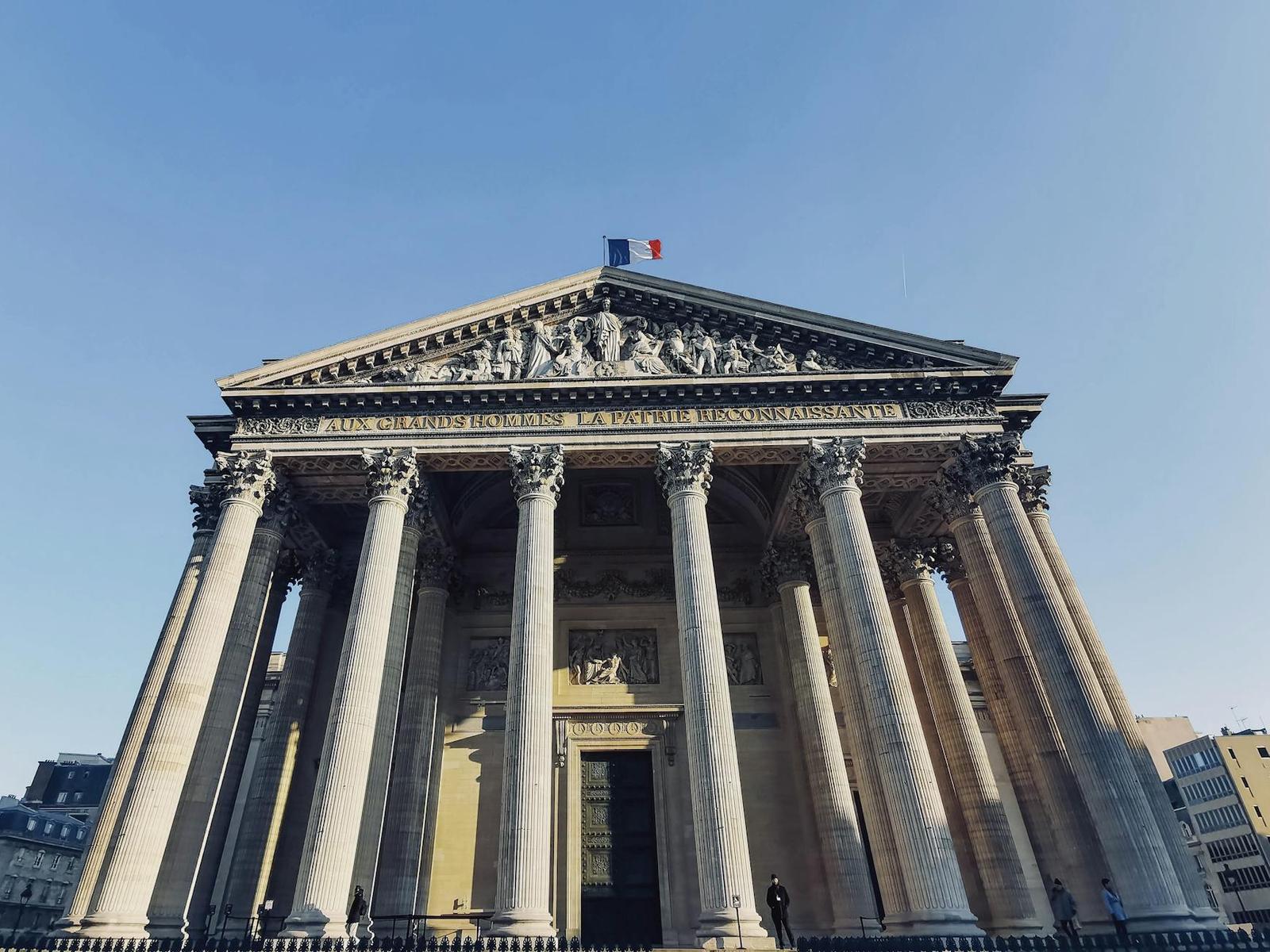 Low angle shot of the iconic Panthéon in Paris with a clear blue sky
