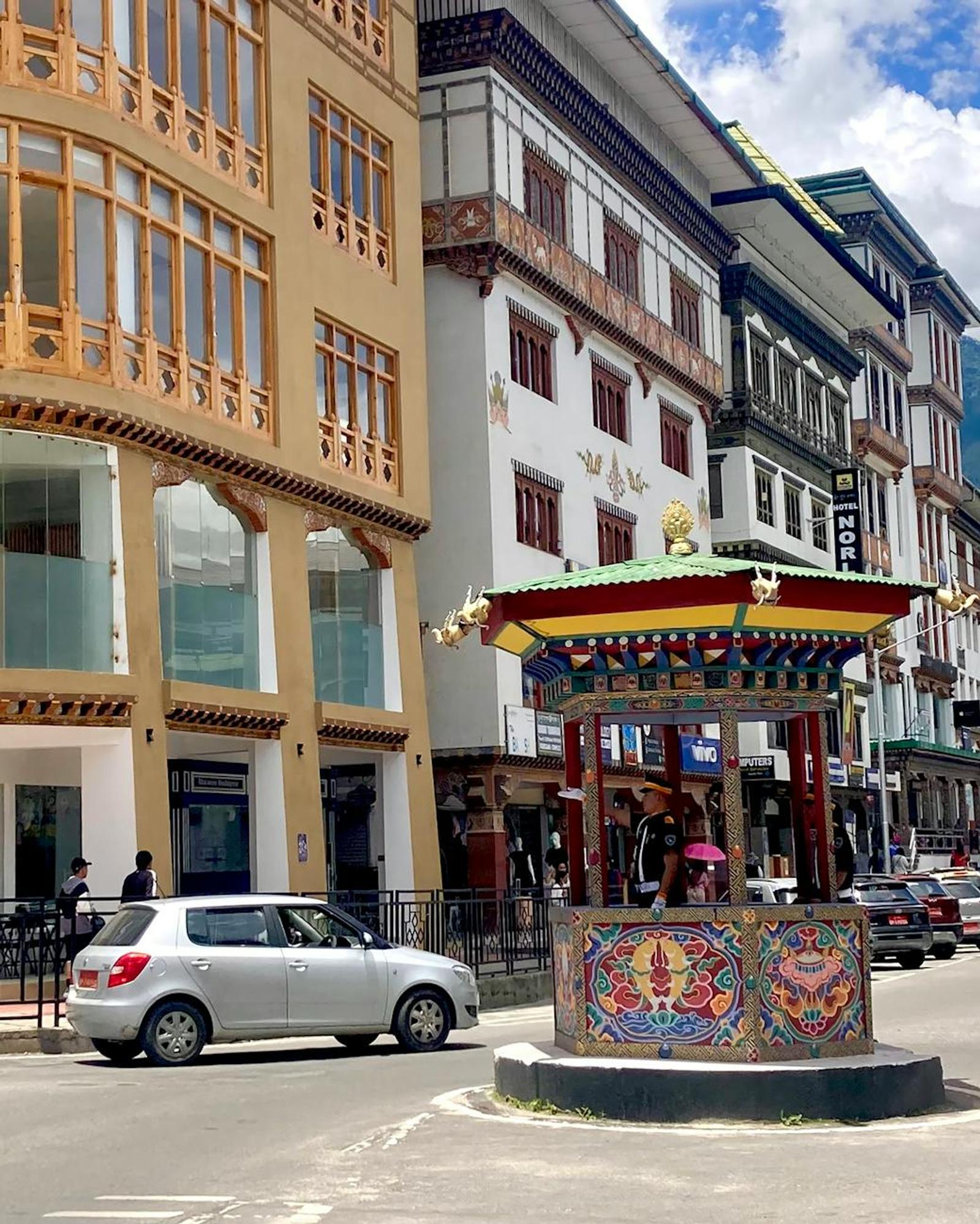 Colorful traditional architecture and vibrant traffic scene in Thimphu, Bhutan