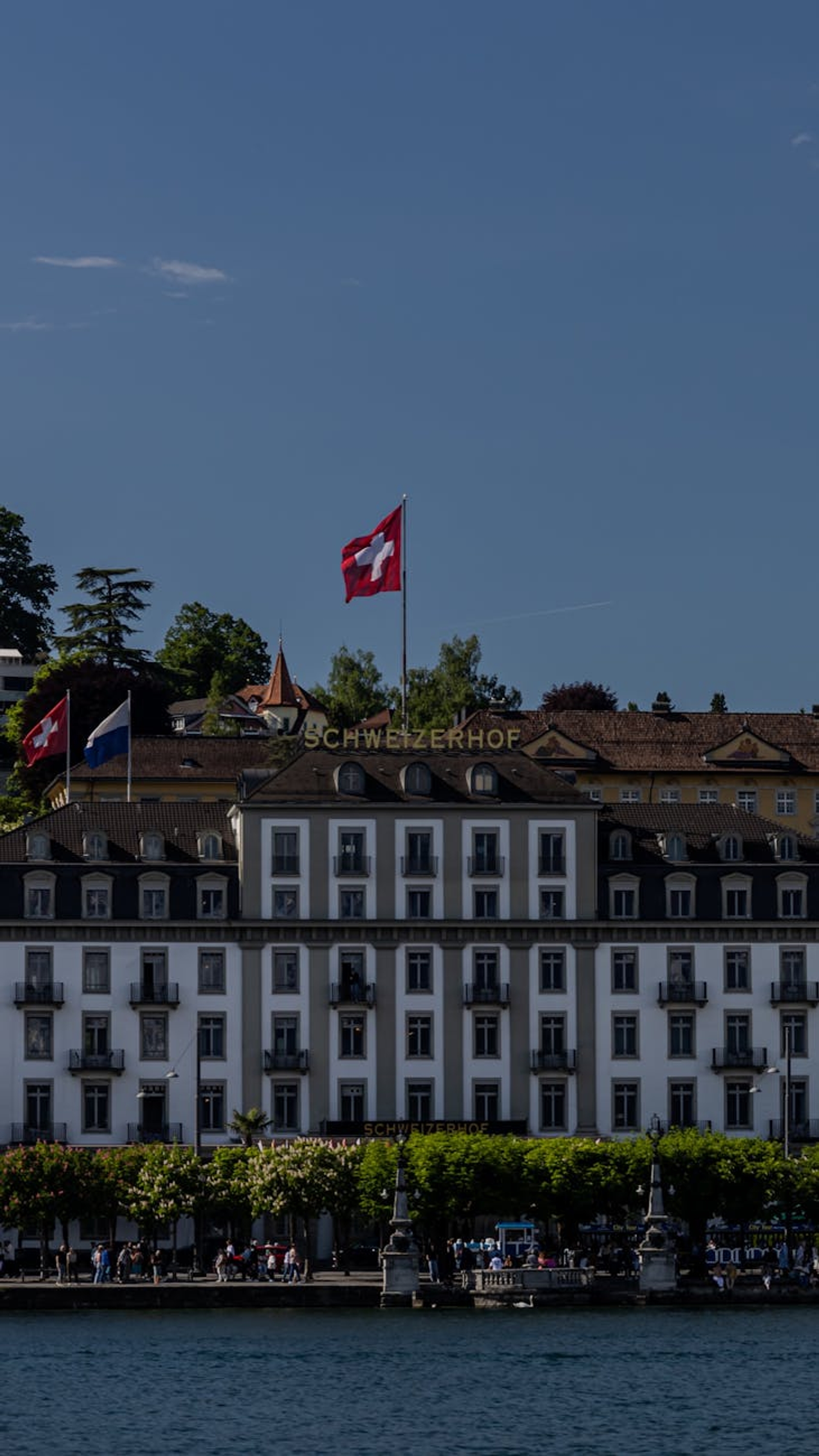 The iconic Schweizerhof Hotel with a Swiss flag