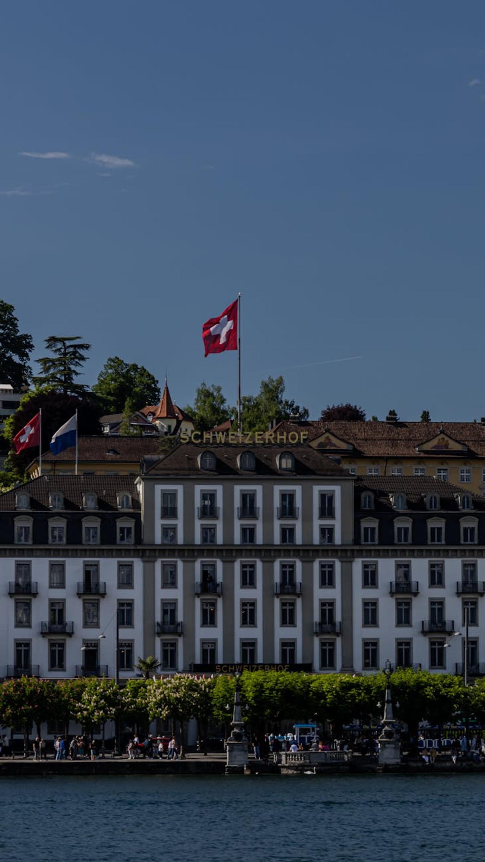 The iconic Schweizerhof Hotel with a Swiss flag