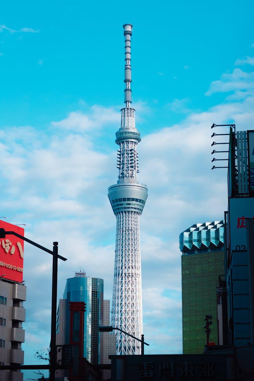 Tokyo Skytree rising above city buildings under a partly cloudy sky