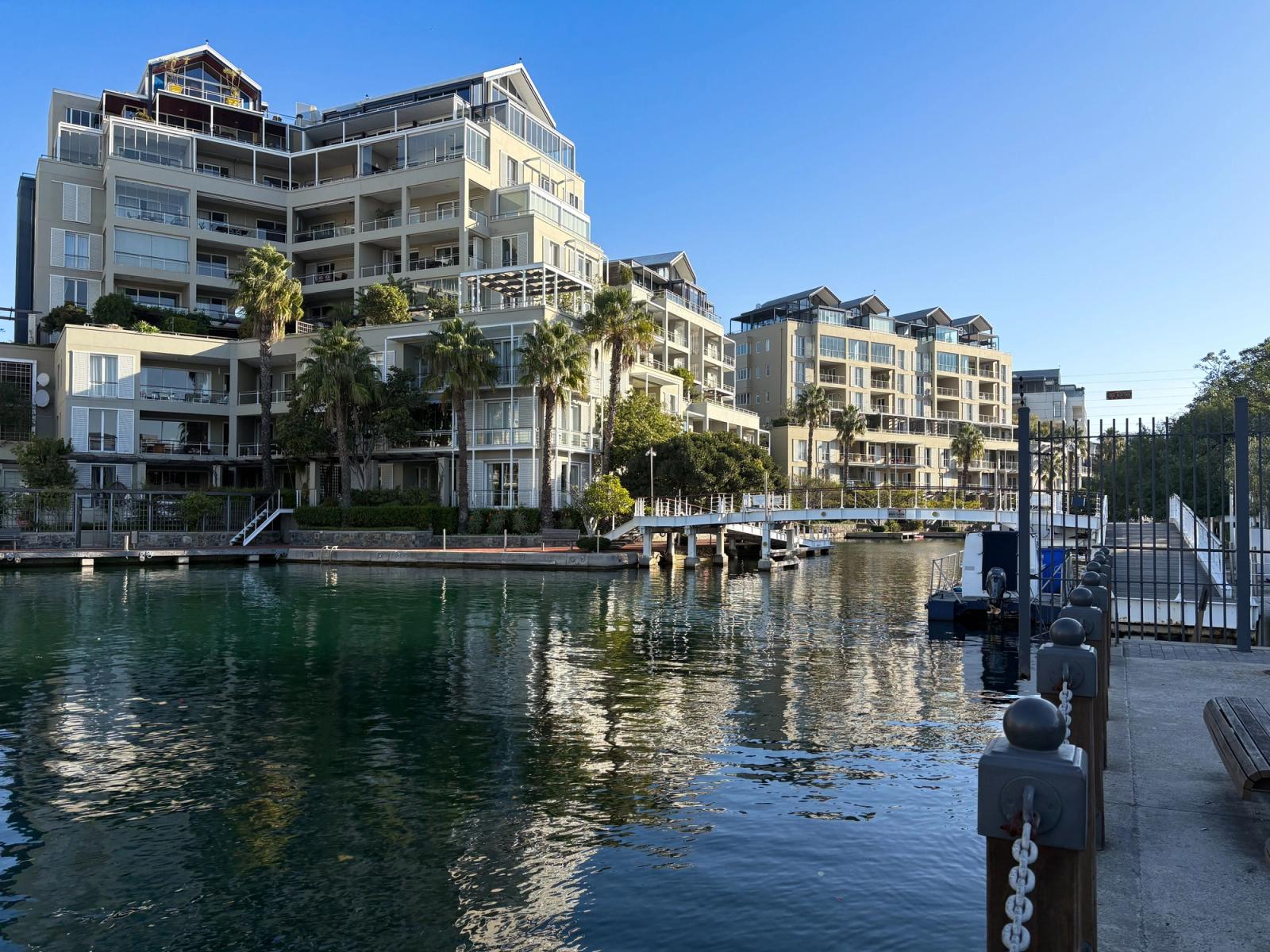 Scenic view of modern apartments at Cape Town waterfront with marina reflection