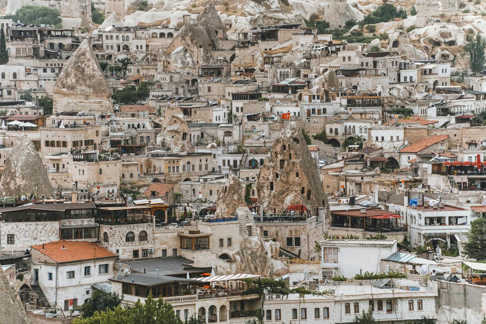 Dense hillside town of terraced buildings carved into pale rock