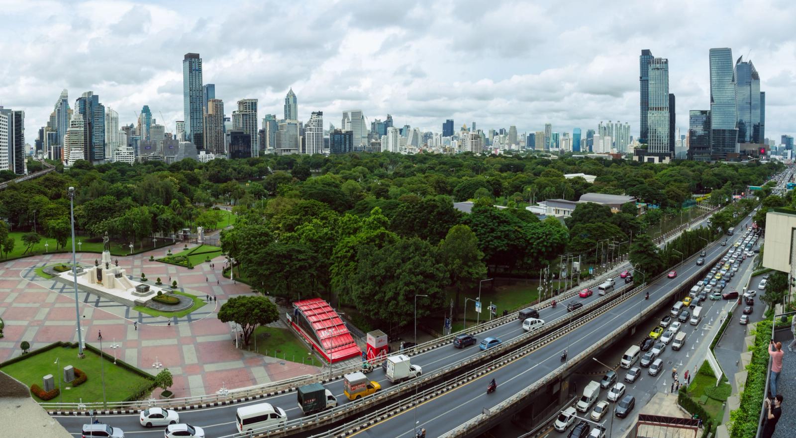 Stunning aerial view of Bangkok's skyline and Lumphini Park showcasing urban life and green space
