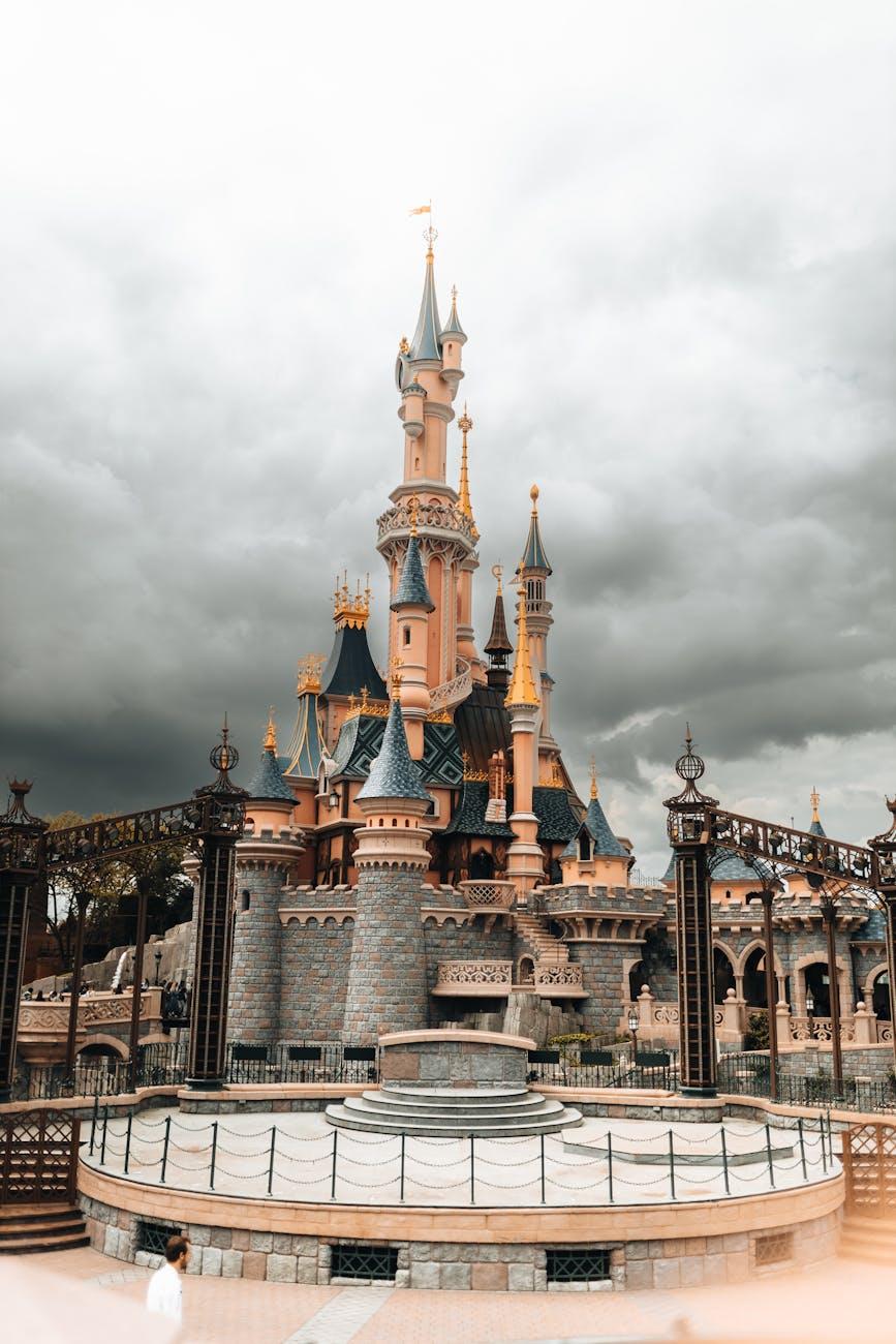 Explore the magical architecture of Disneyland Paris castle under dramatic cloudy skies