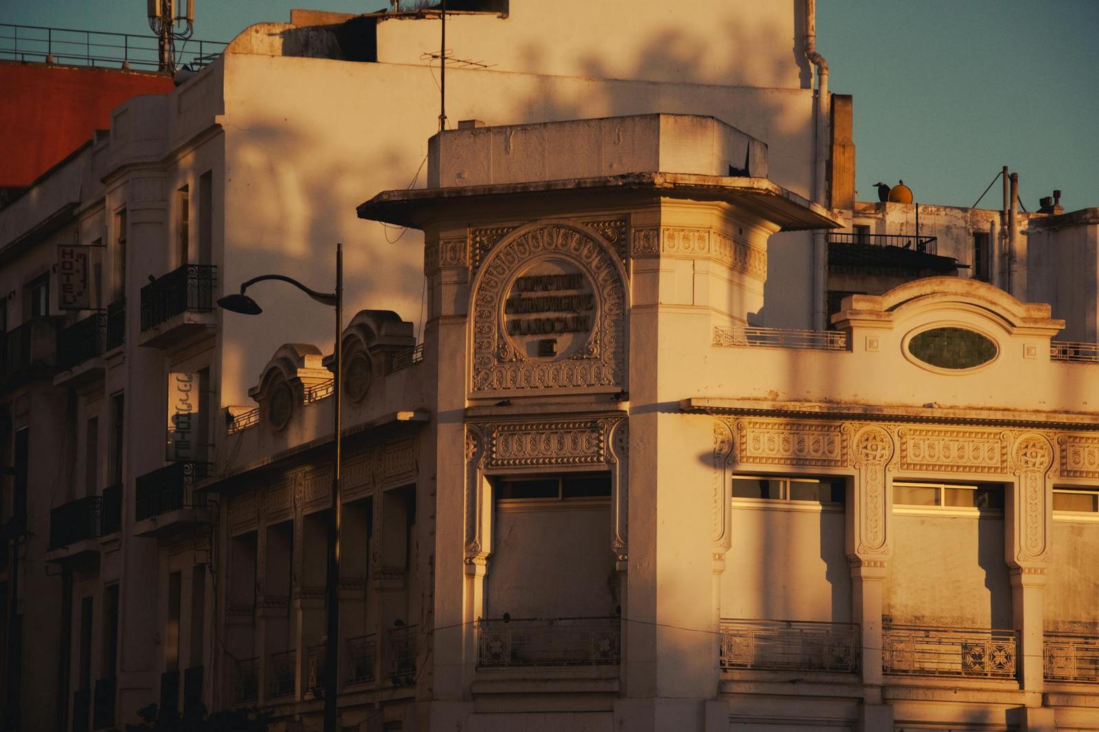 A corner building with decorative stonework catching warm evening light