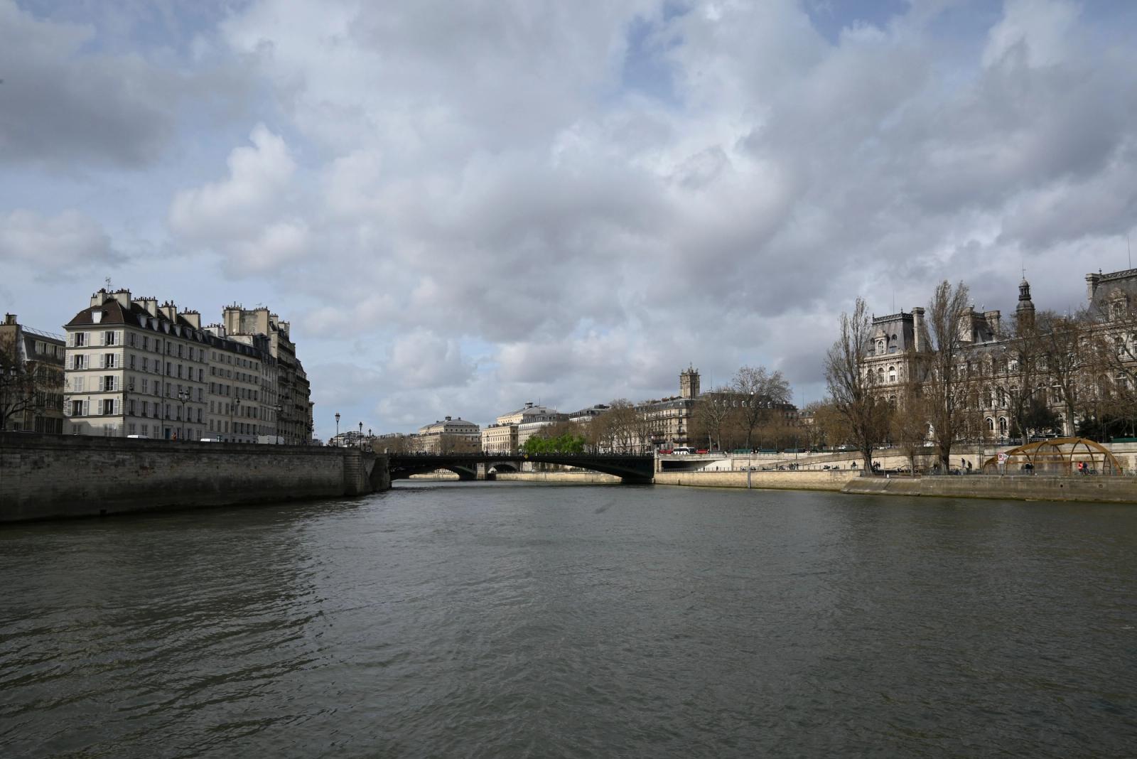 Cloudy day over the Seine in Paris with bridges and historic buildings lining the river