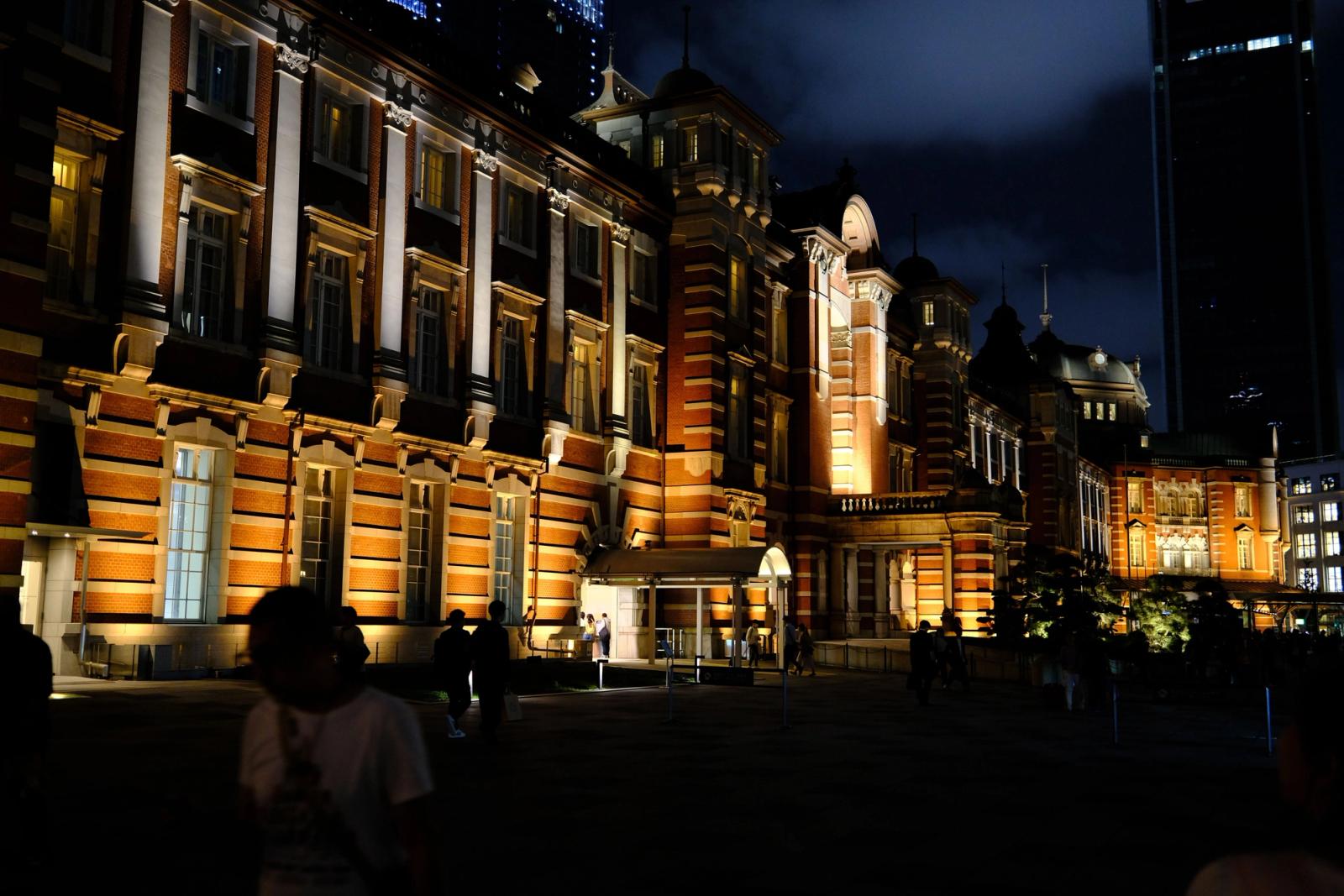 Night view of Tokyo Station's illuminated facade, displaying stunning architectural details in vibrant lighting