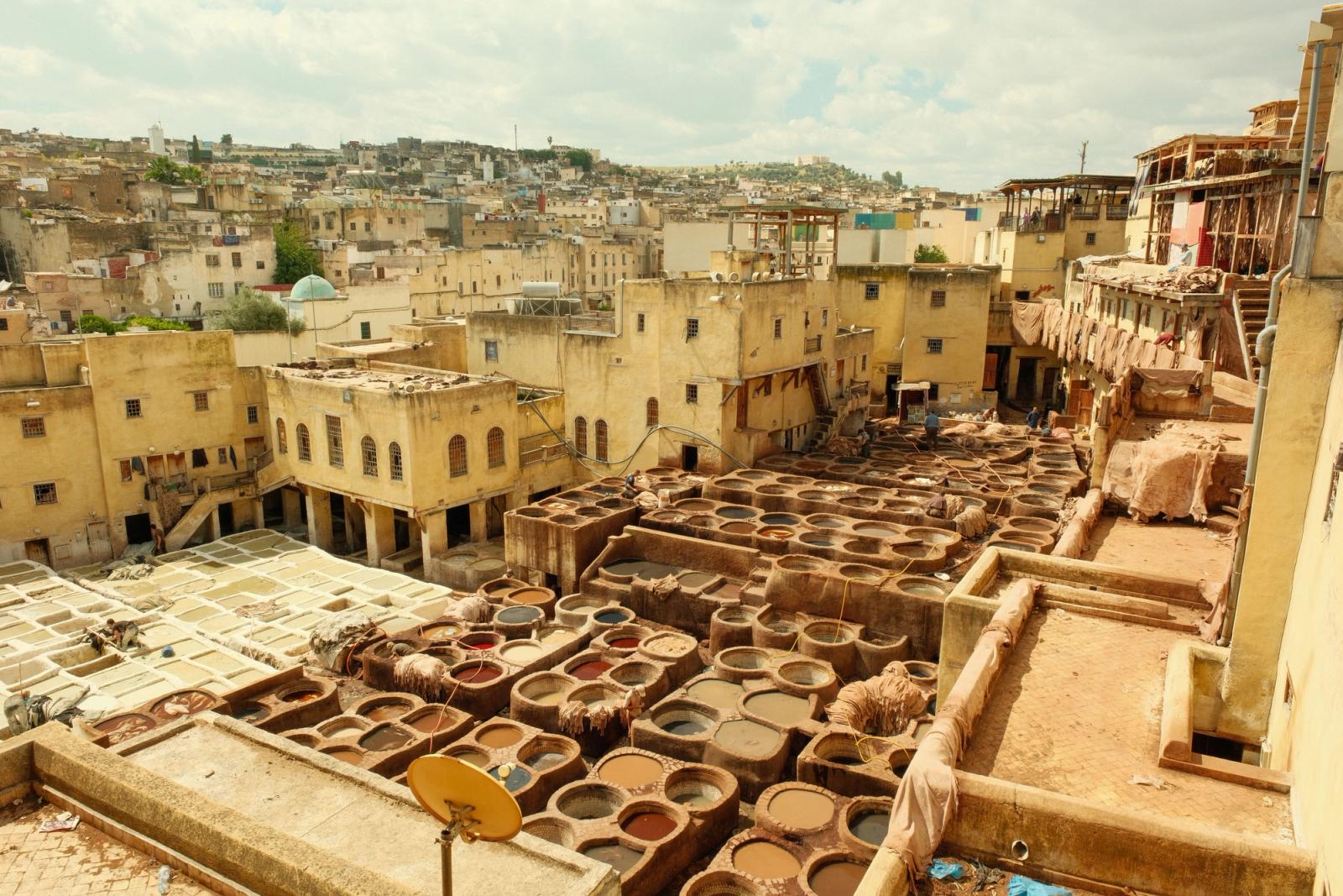 View of the historic tanneries in Fes, Morocco, showcasing traditional leather tanning vats and architecture